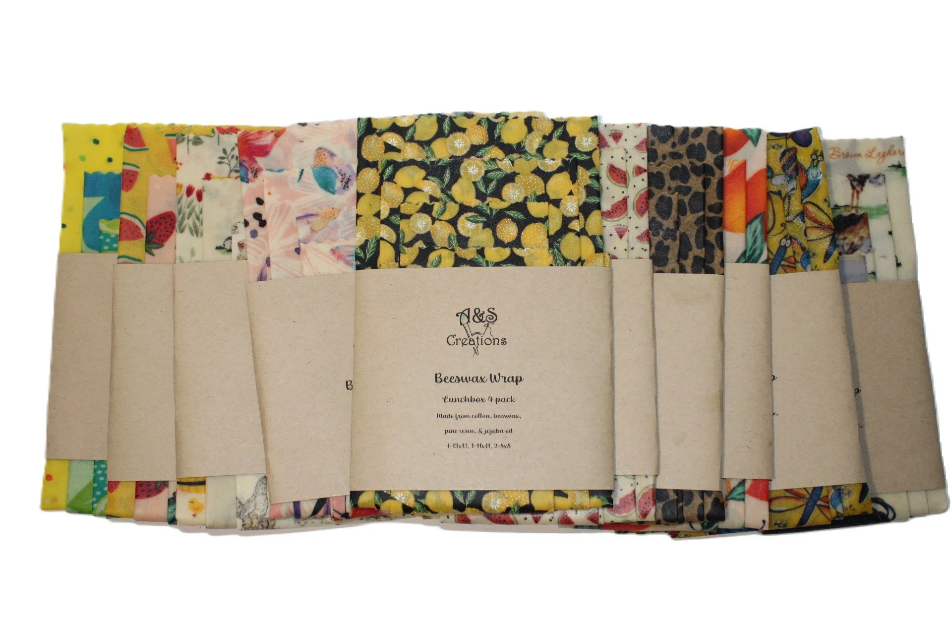 Set of four bee’s wax food wraps with colorful patterns, packaged in a paper sleeve labeled "A&S Creations Bee’s wax Wrap lunchbox 4 pack".