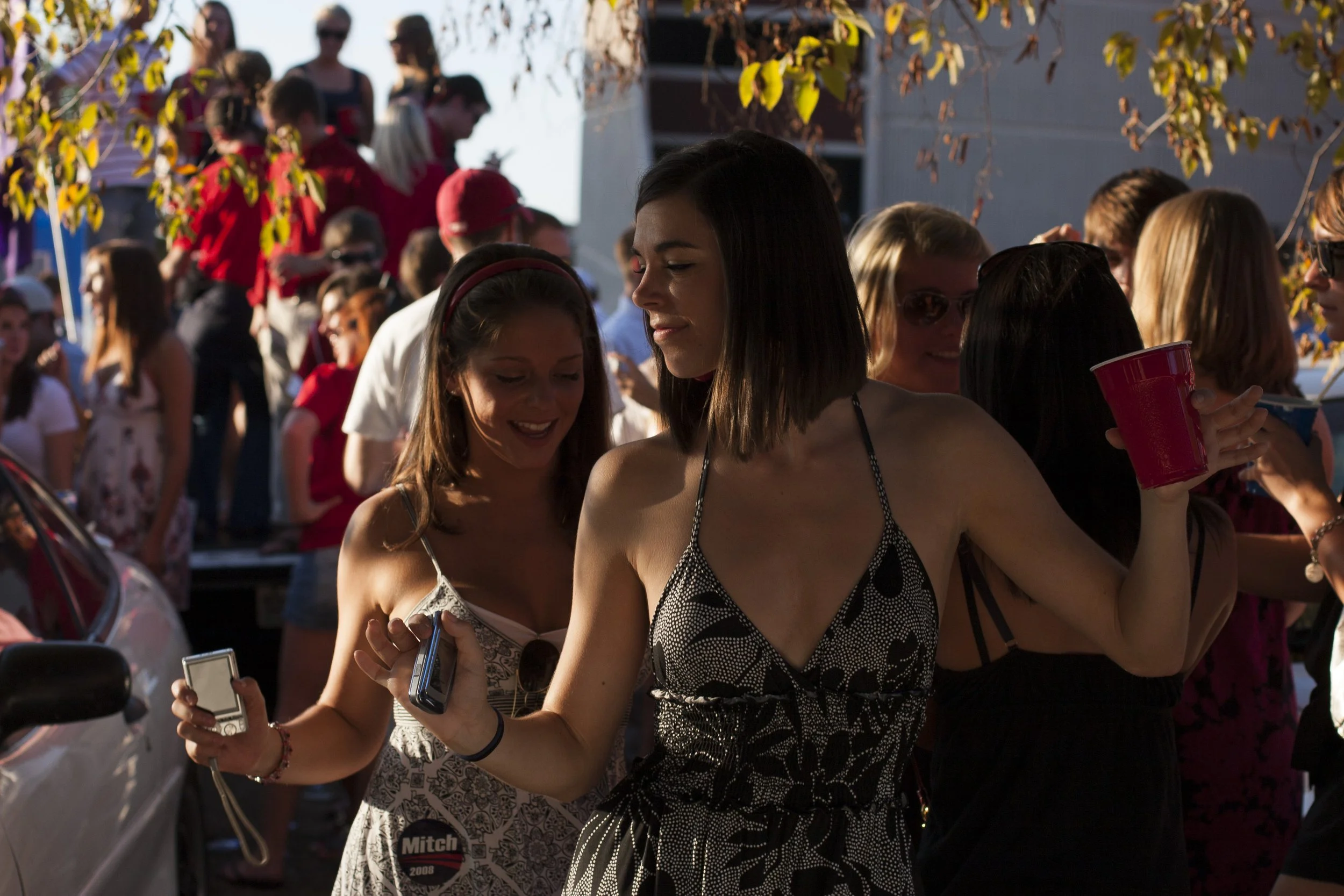 Women dance at a tailgating party during Homecoming celebrations at Western Kentucky University in Bowling Green, Ky.