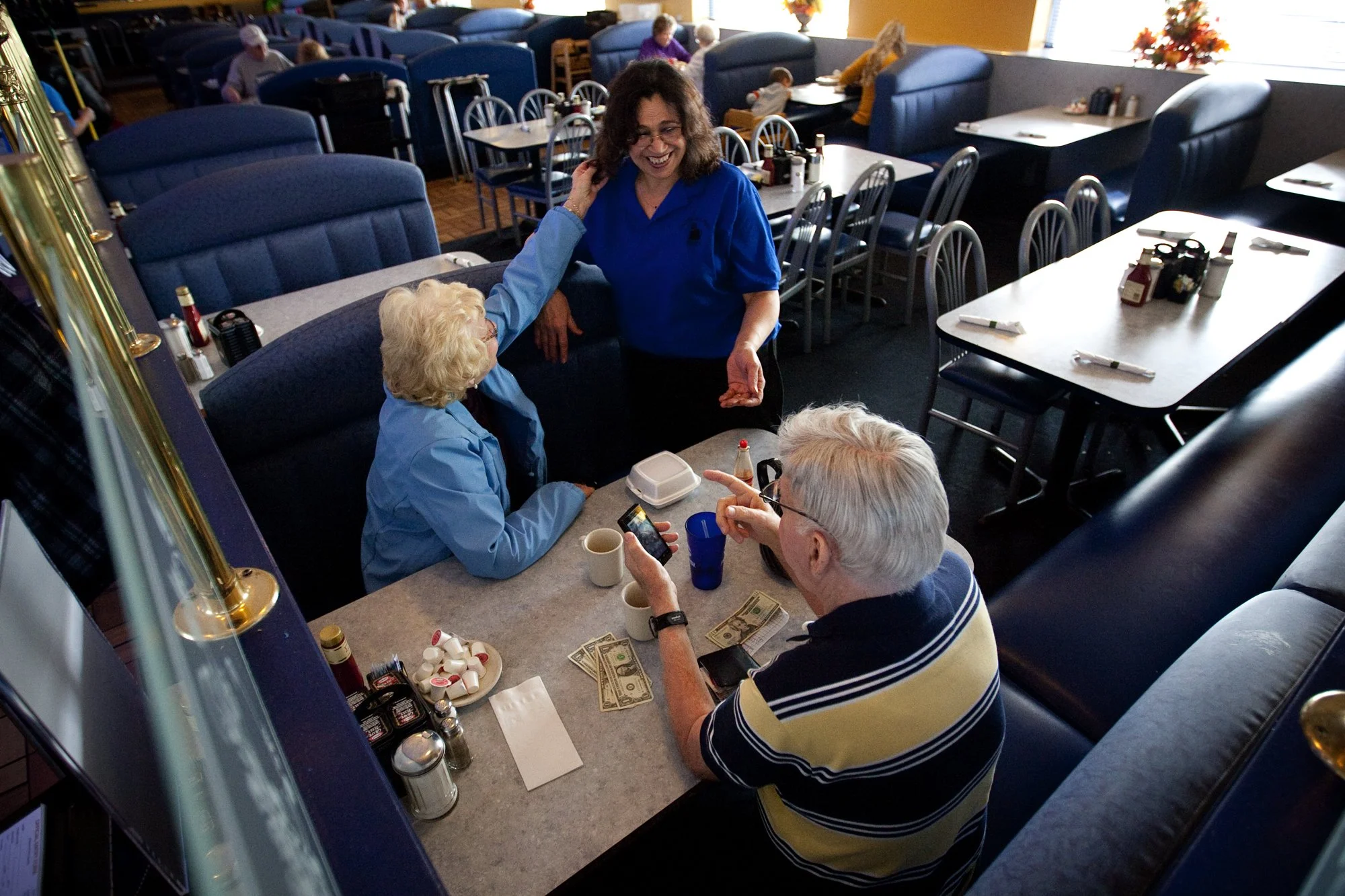 Samia Chandra, 58, talks with customers Mary Ann and Rich Helman at the Colonial Park Diner in Harrisburg, Pa.