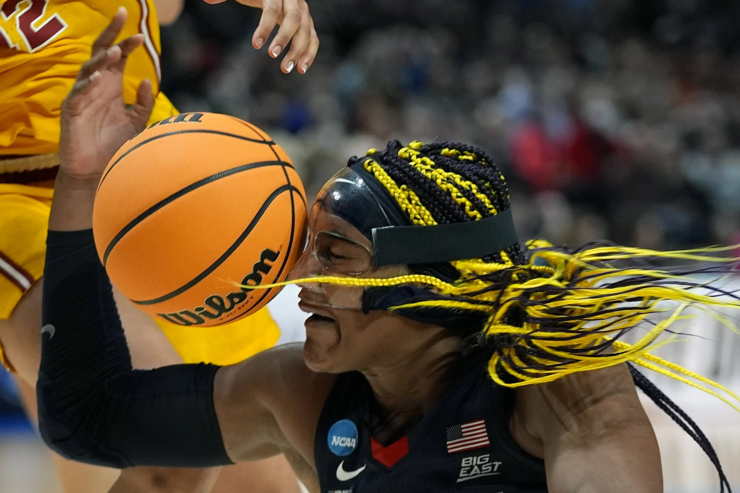 UConn forward Aaliyah Edwards gets hit in the face with a ball during the second half of an Elite Eight college basketball game against Southern California in the women’s NCAA Tournament, Monday, April 1, 2024, in Portland, Ore.
