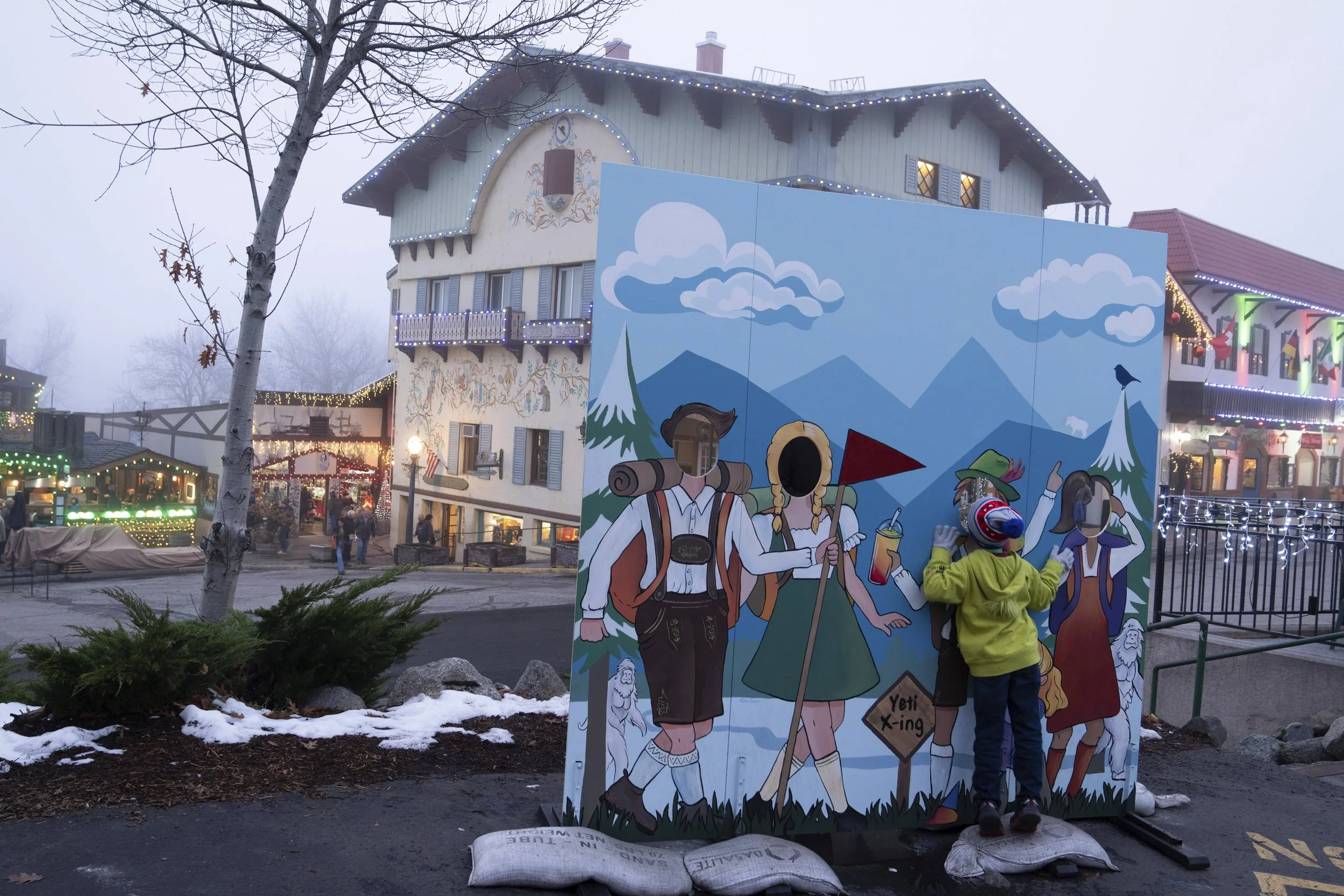 A child stands on their toes to look out of a cutout on Tuesday, Nov. 26, 2024, in Leavenworth, Wash.