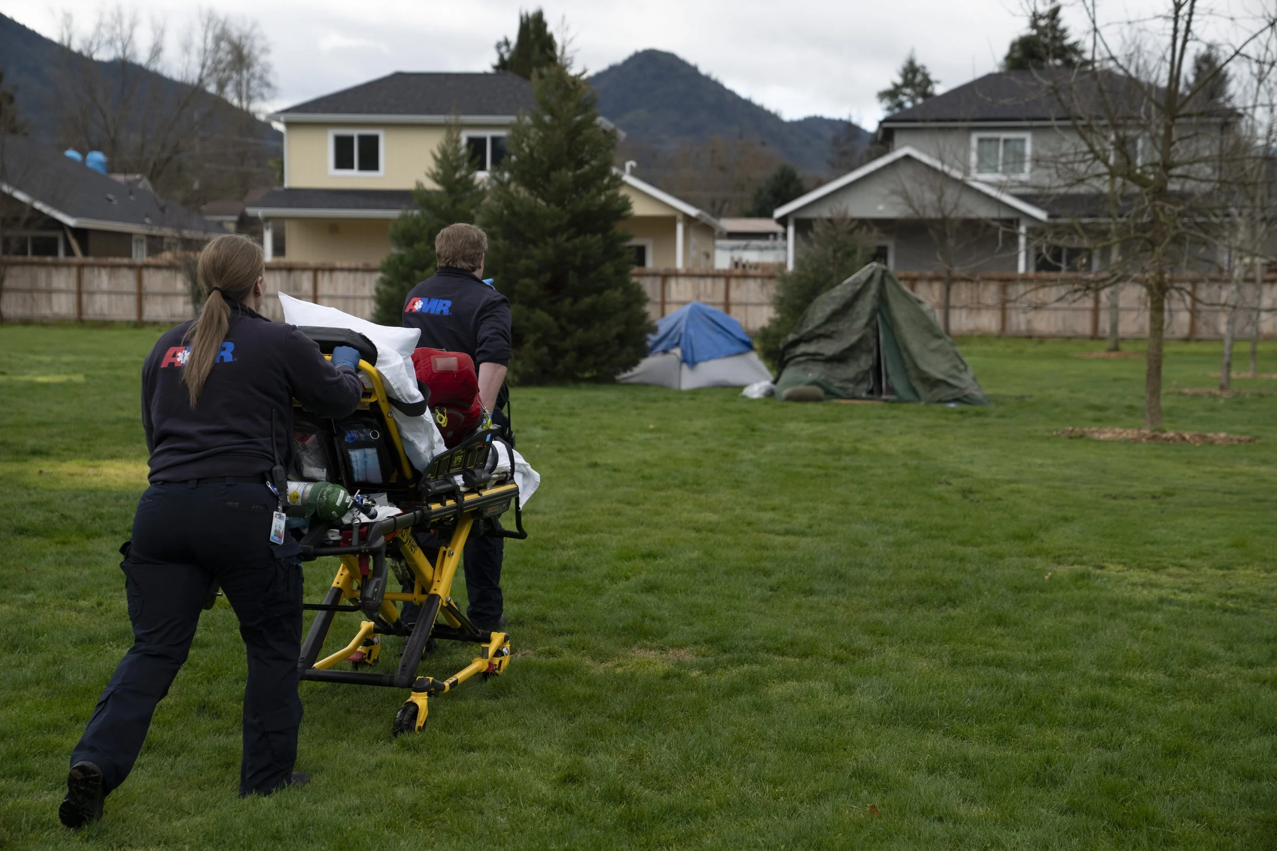 Emergency responders walk to a tent after a welfare check was called in by relatives on Saturday, March 23, 2024, in Grants Pass, Ore. 