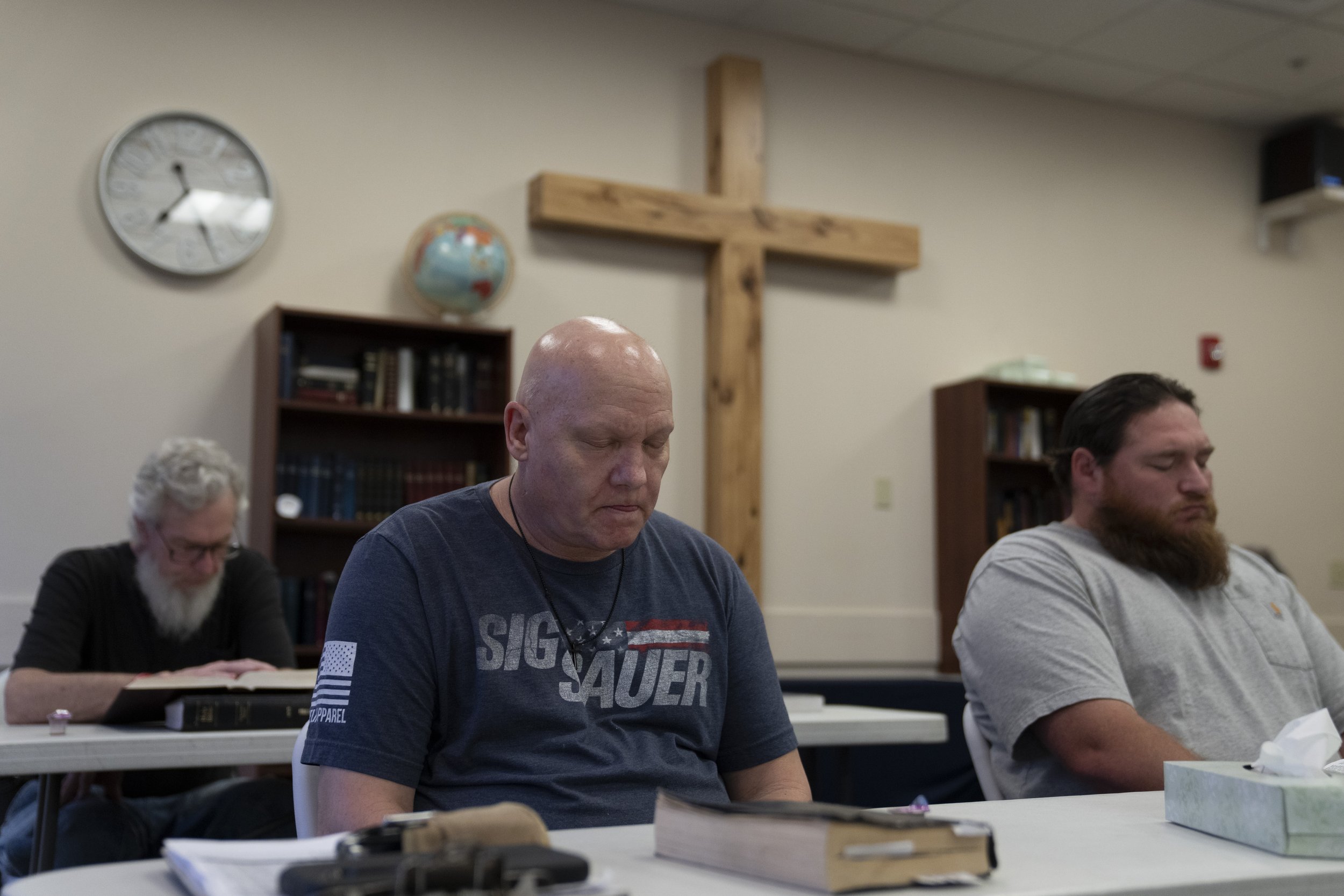 Brian Wright, center, prays during bible study at Gospel Rescue Mission, Thursday, March 21, 2024, in Grants Pass, Ore. 