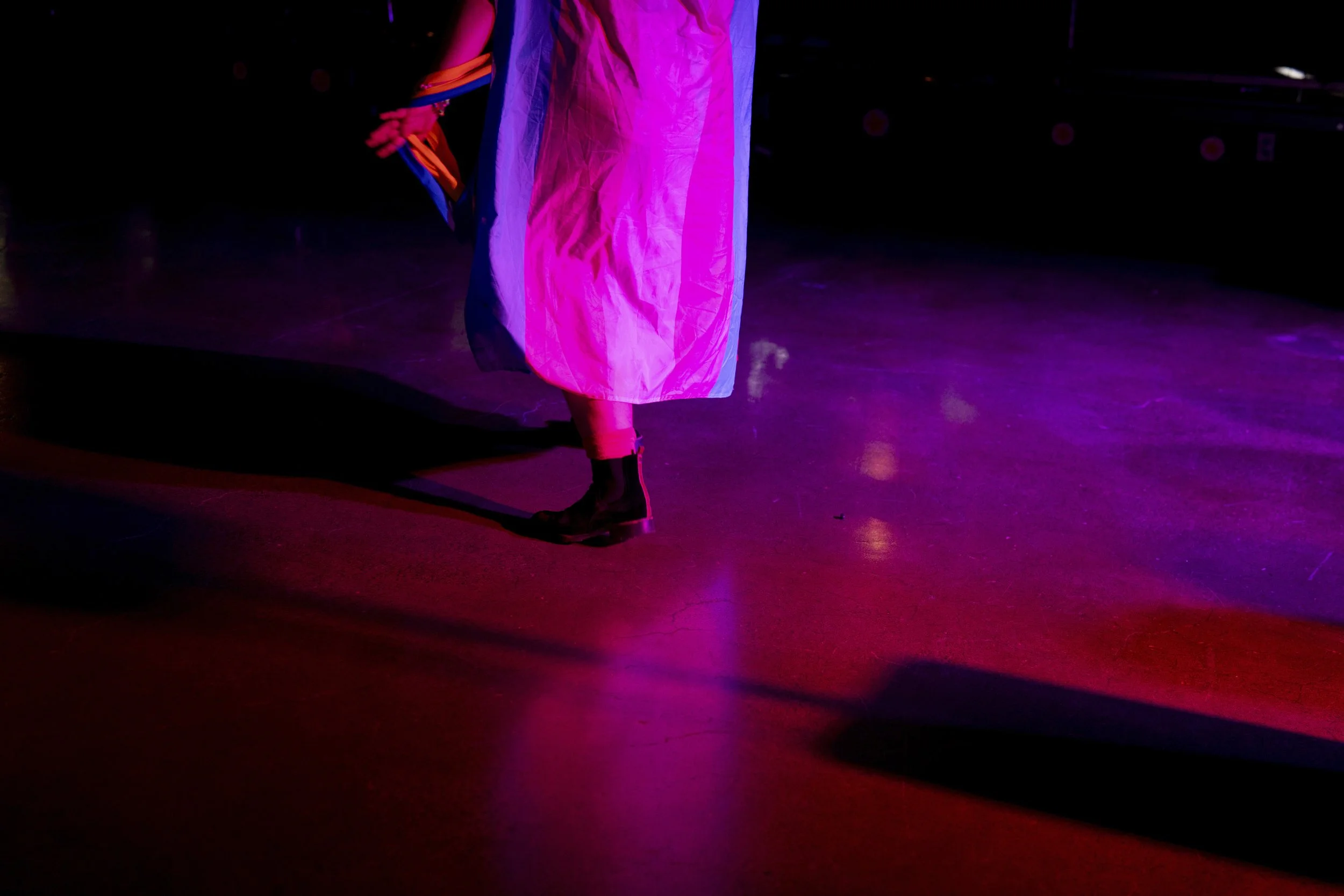 Ambrose wears a transgender pride flag while dancing during a “Pink Pony Prom” on Friday, May 30, 2025, in Portland, Ore. 