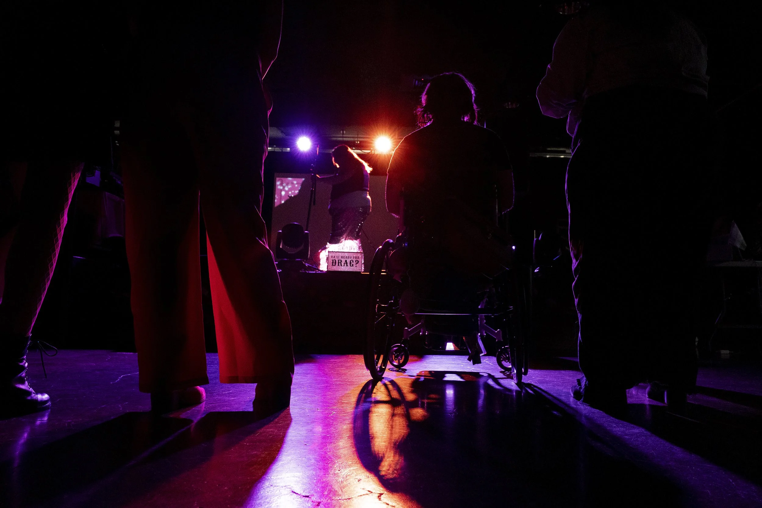 Elliott Auel, second from right, watches drag king Luciano VeriNotti prepare to perform during a “Pink Pony Prom” on Friday, May 30, 2025, in Portland, Ore.