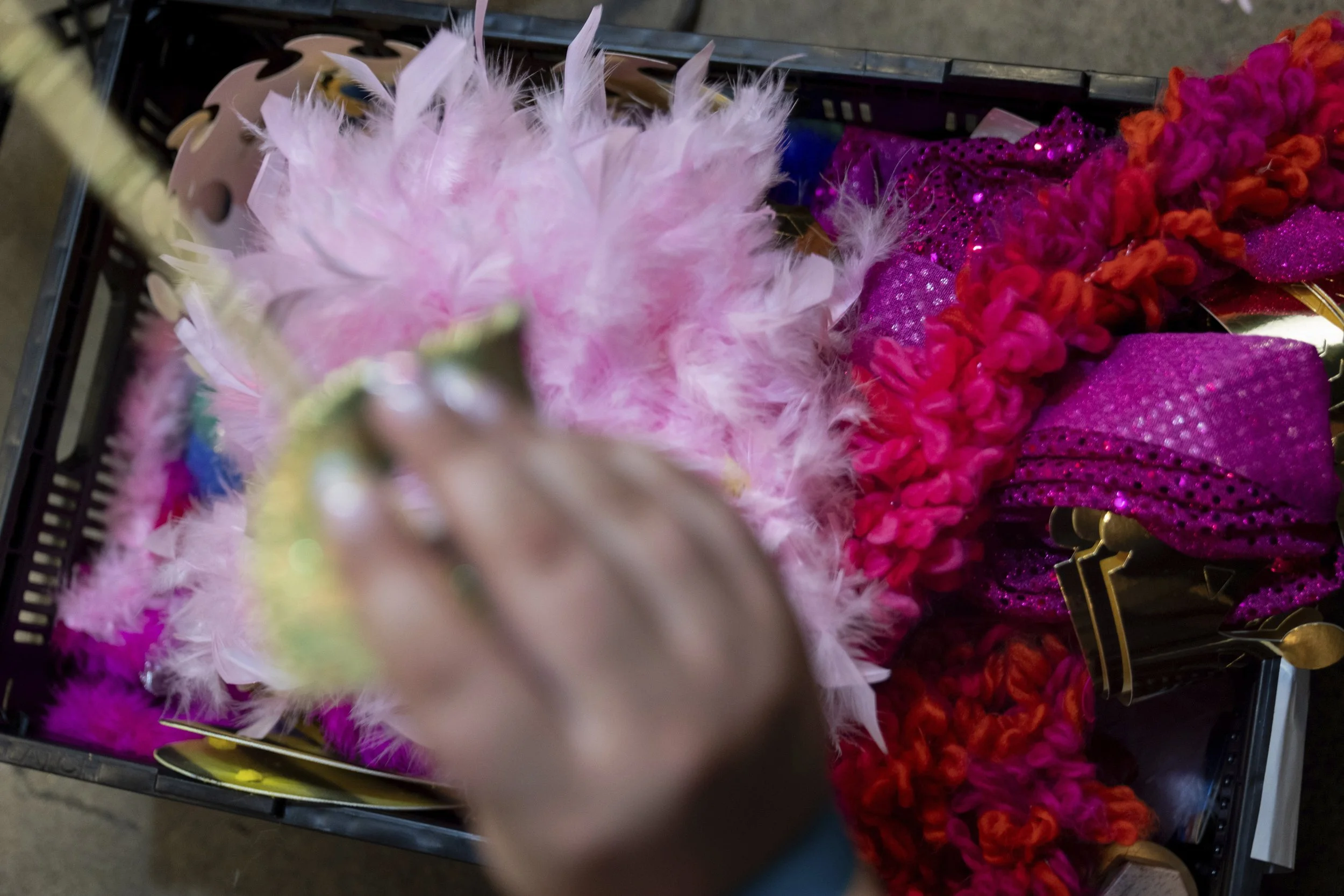 A person takes out a mask from a bin of costume accessories during a "Pink Pony Prom" on Friday, May 30, 2025, in Portland, Ore.