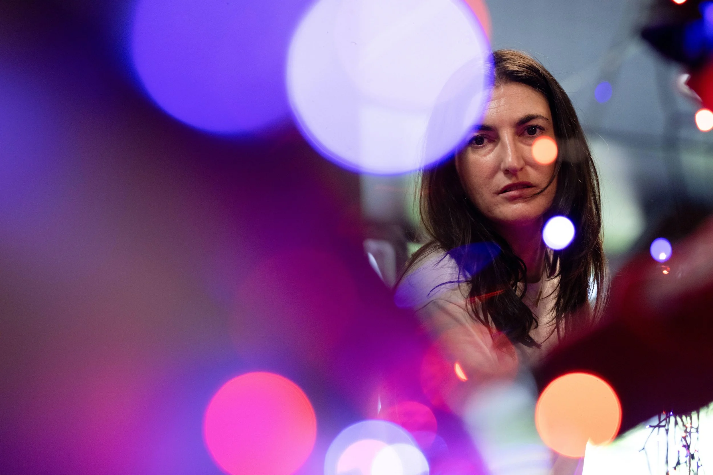 Megan Baer, associate director of communications at New Avenues for Youth, strings lights before a “Pink Pony Prom” organized by the Sexual & Gender Minority Youth Resource Center, part of New Avenues for Youth, a nonprofit dedicated to ending youth 