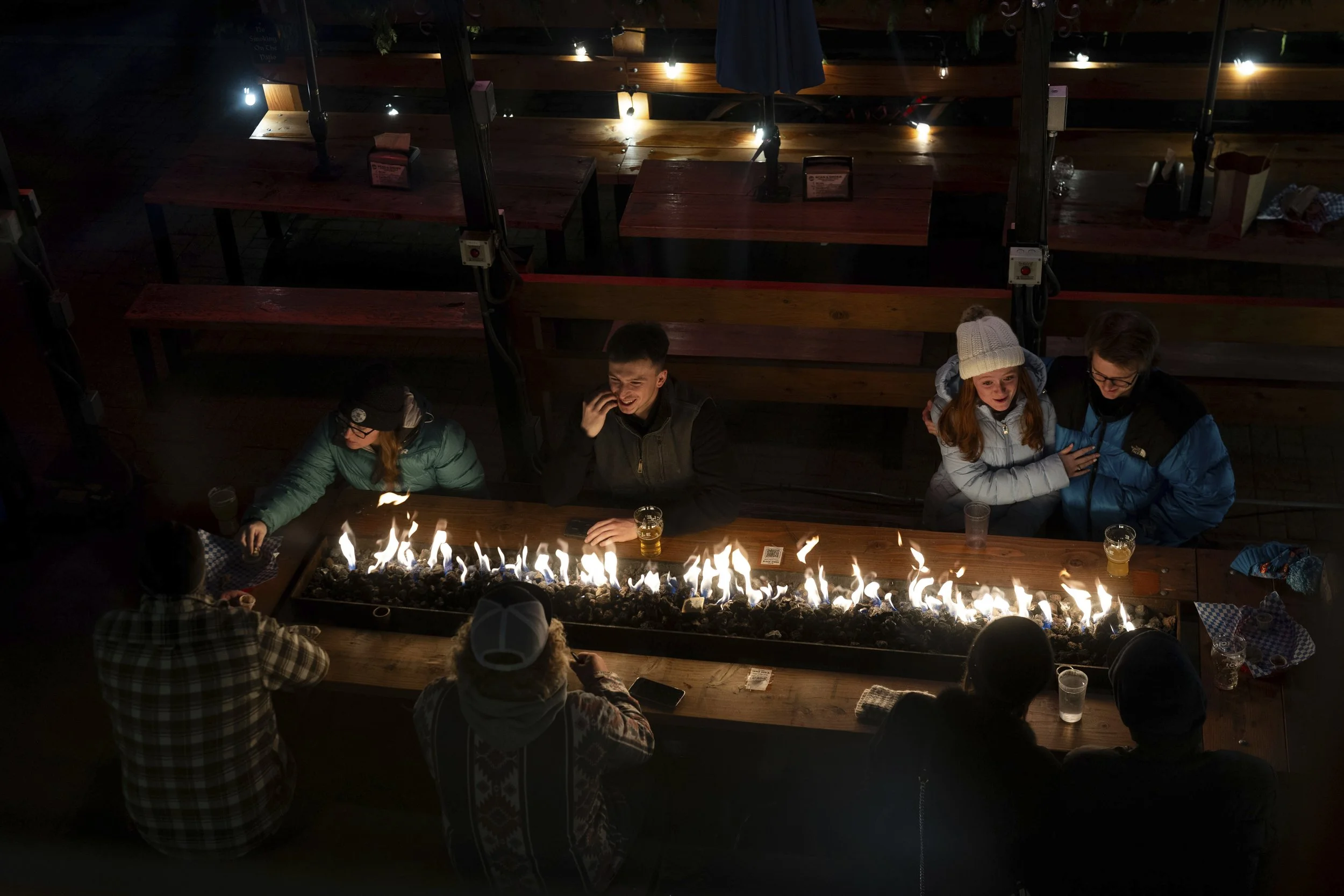 People sit by a fire at Icicle Brewing Company on Wednesday, Nov. 27, 2024, in Leavenworth, Wash.