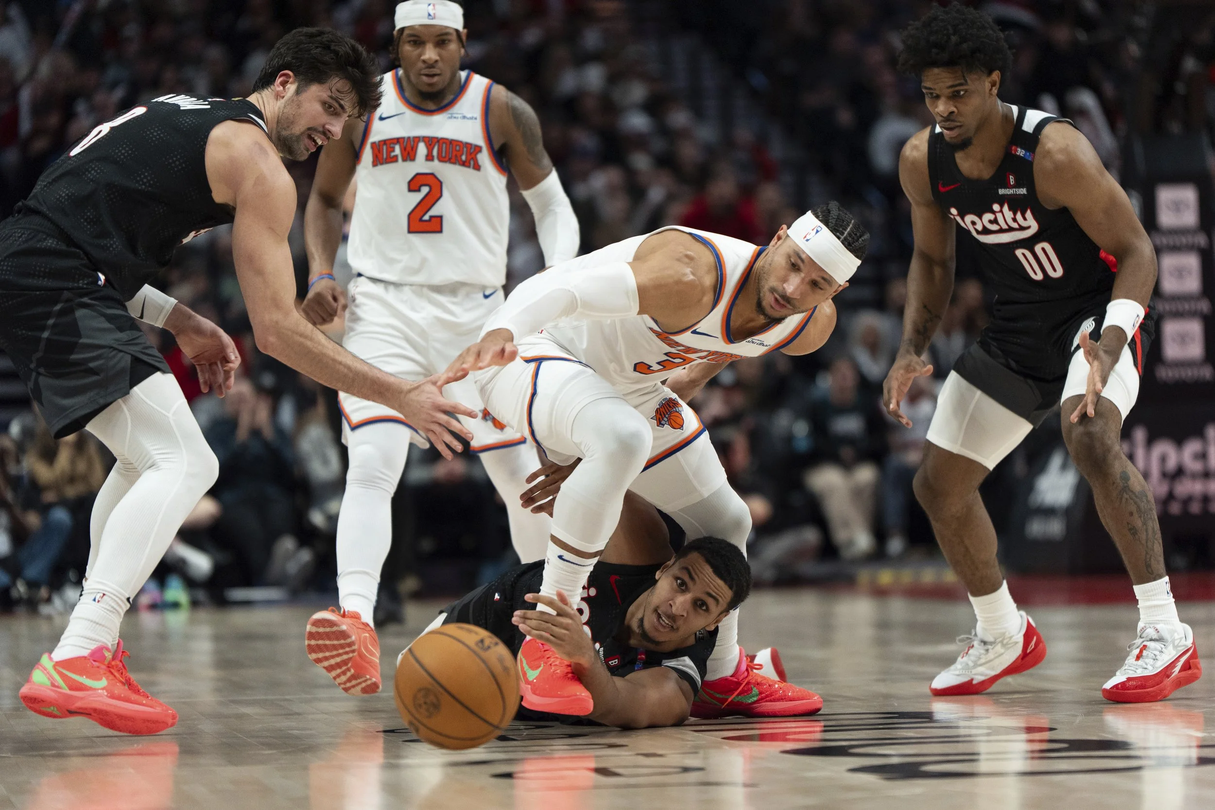 From left, Portland Trail Blazers forward Deni Avdija, New York Knicks guard Miles McBride (2) New York Knicks guard Josh Hart (3) Portland Trail Blazers forward Kris Murray, bottom, and Portland Trail Blazers guard Scoot Henderson (00) go for a loos