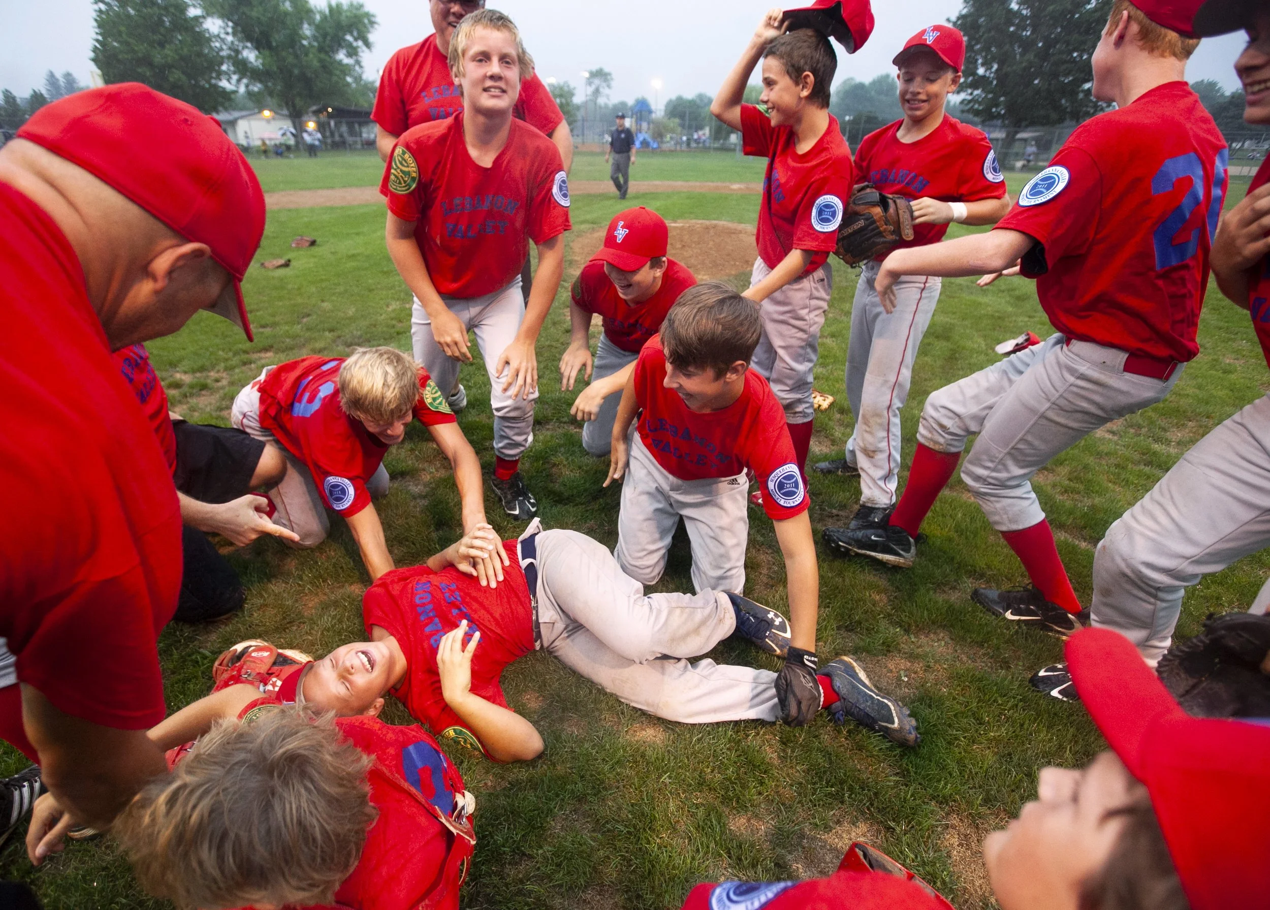 Lebanon Valley’s Cole Miller, center on the ground, celebrates with teammates after their 3-0 victory against Keystone Suburban in the Haps Boyer Central Penn Midget Baseball title game in Linglestown, Pa.