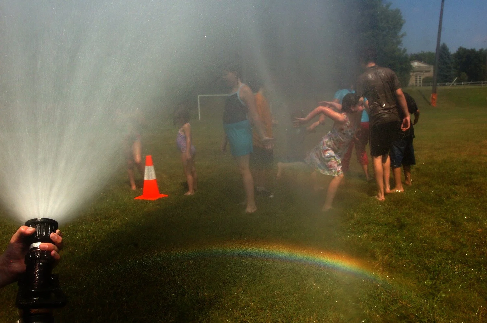 Children play in the water from a fire hose in Monroe, Mich.