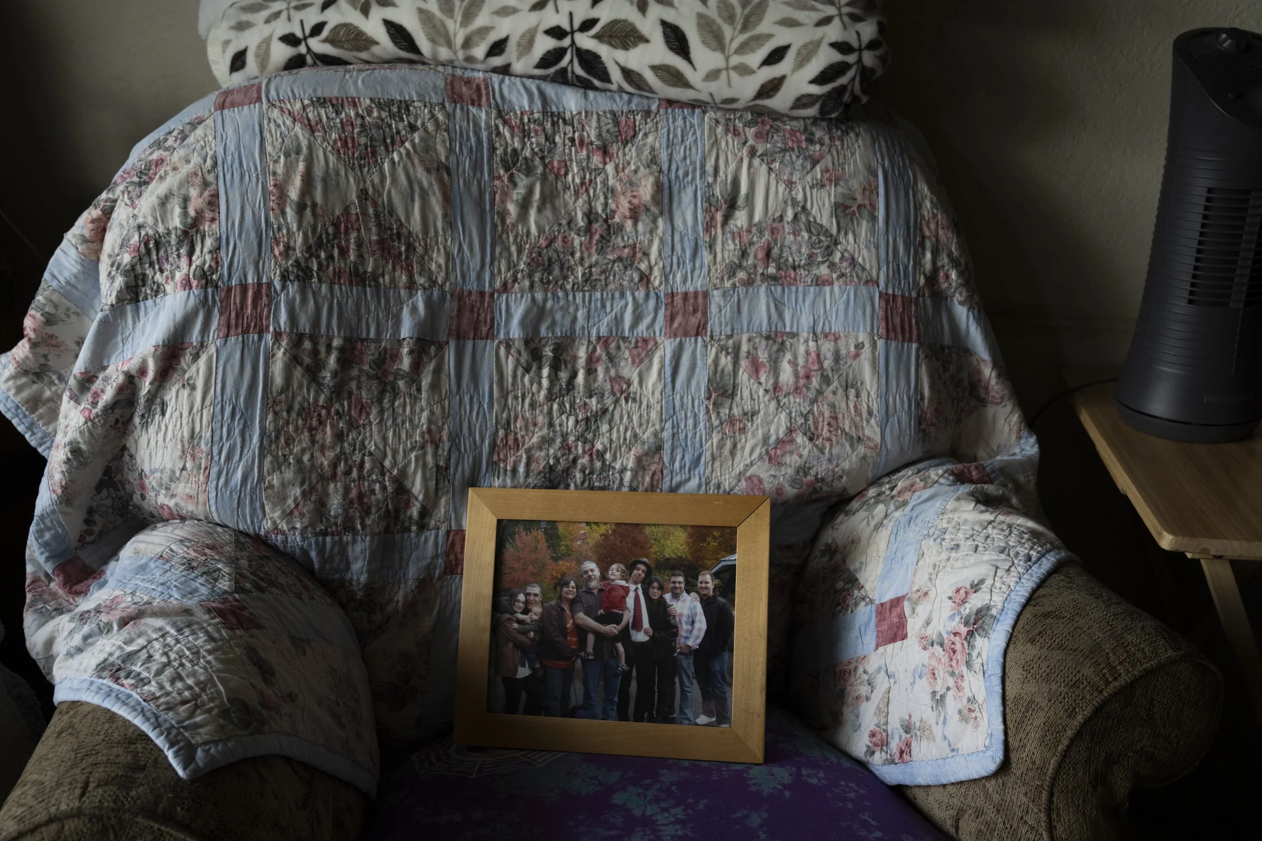 A family photo rests on a chair at the home of Brock Spurgeon on Friday, March 22, 2024, in Grants Pass, Ore. Spurgeon is a member of a self-proclaimed “park watch” group. Spurgeon said the group isn’t against homeless people, but rather public drug 
