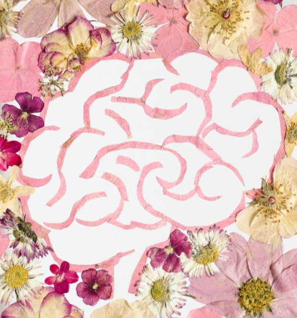 Flowers arranged around a cut-out paper skull in the center.
