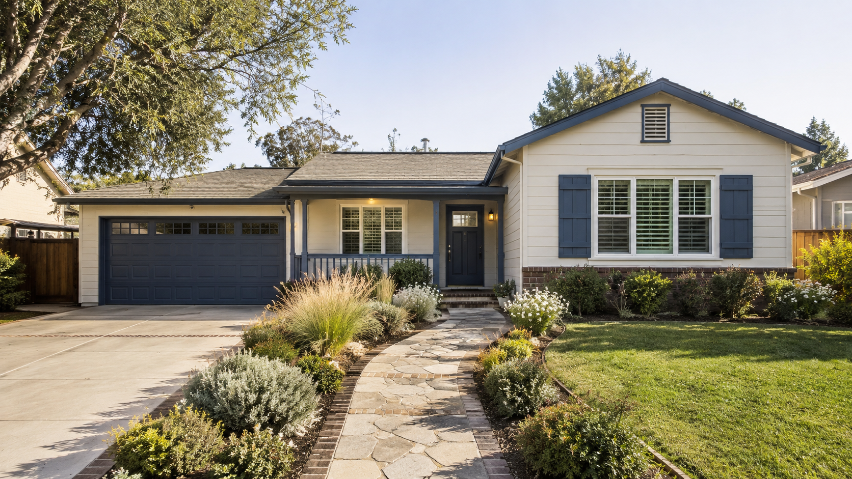 Single-family home with blue trim, an attached garage, and a landscaped front yard