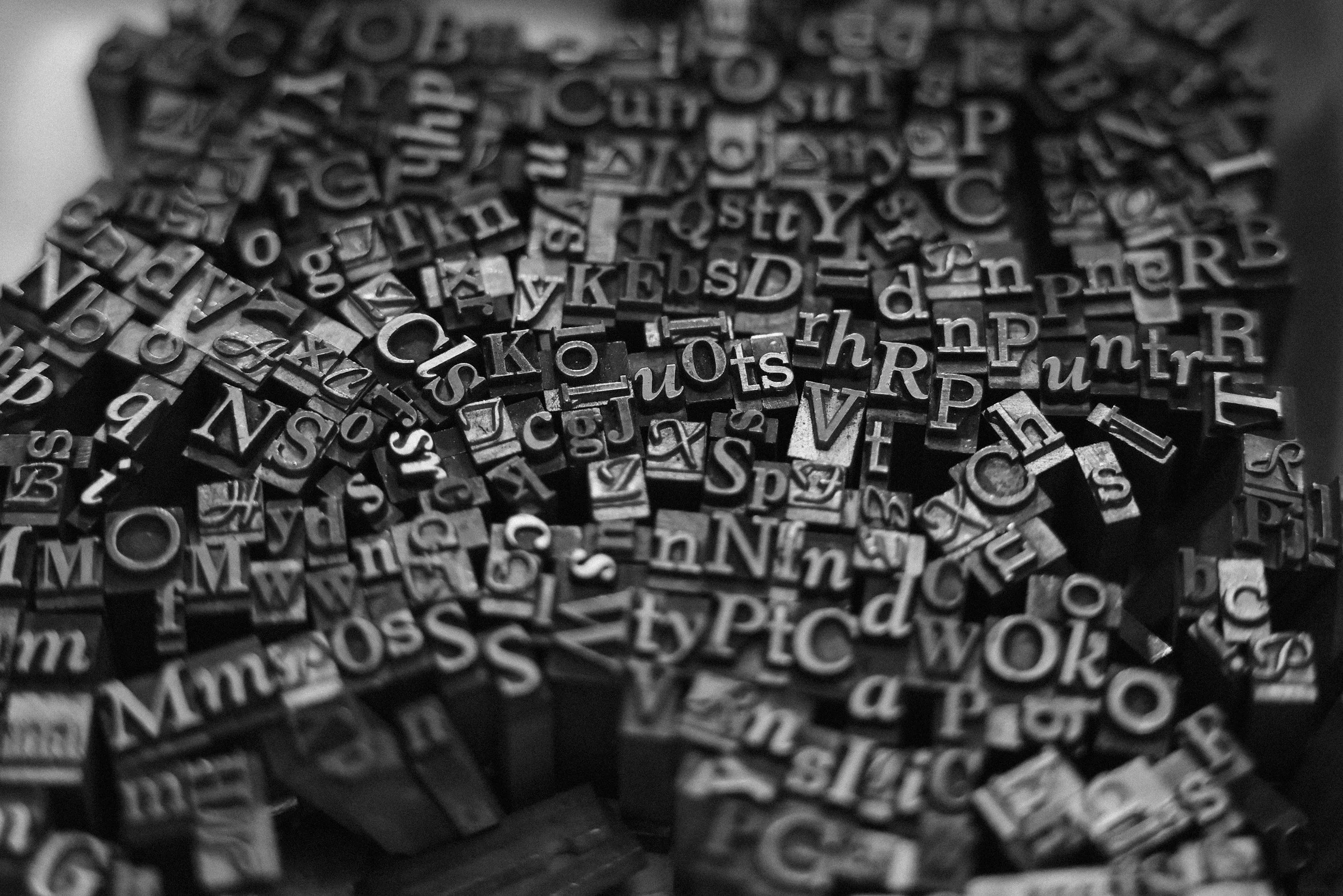 Black and white photograph of assorted letterpress type blocks.