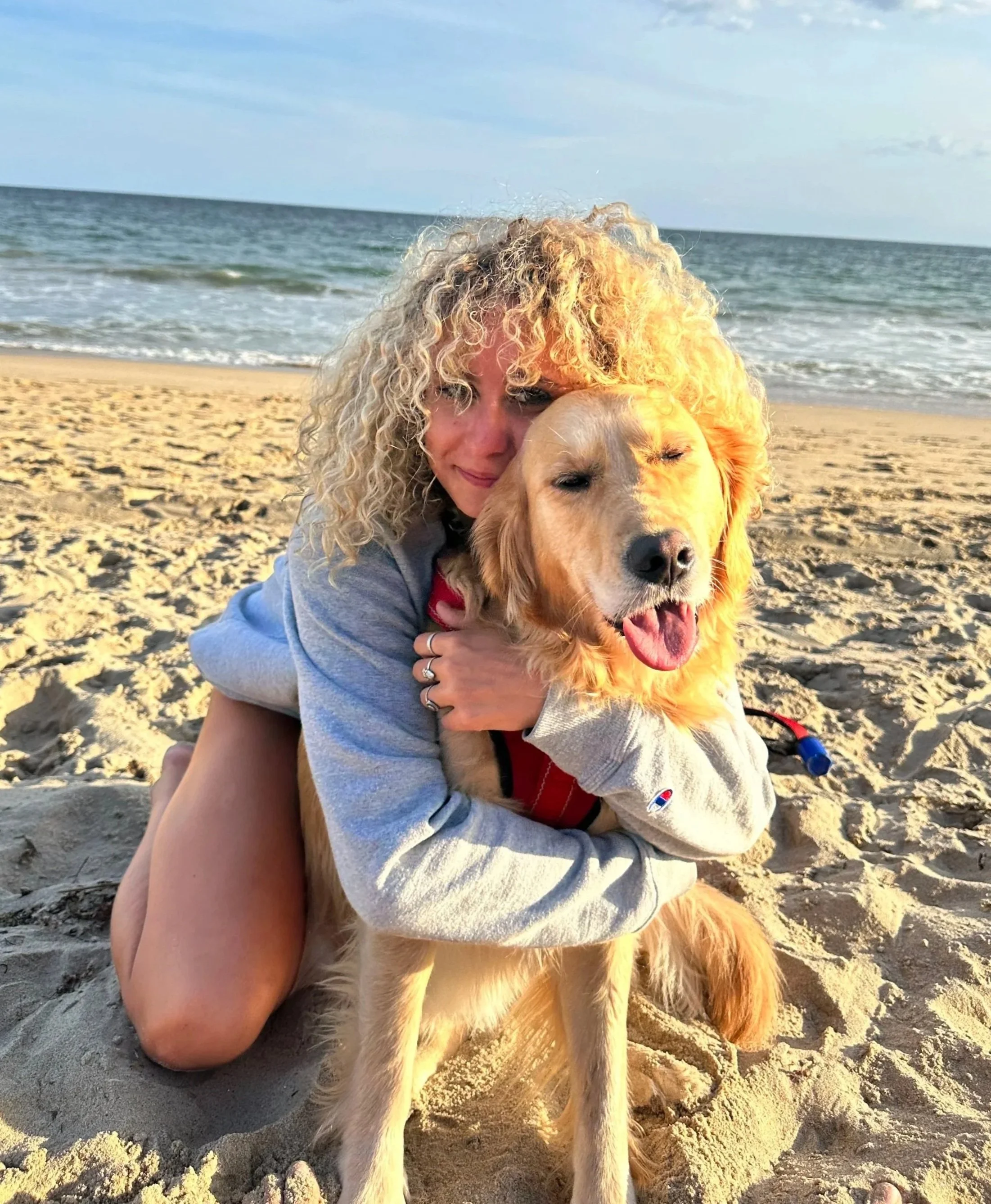 Image of Ciara Gunning hugging her dog at the beach