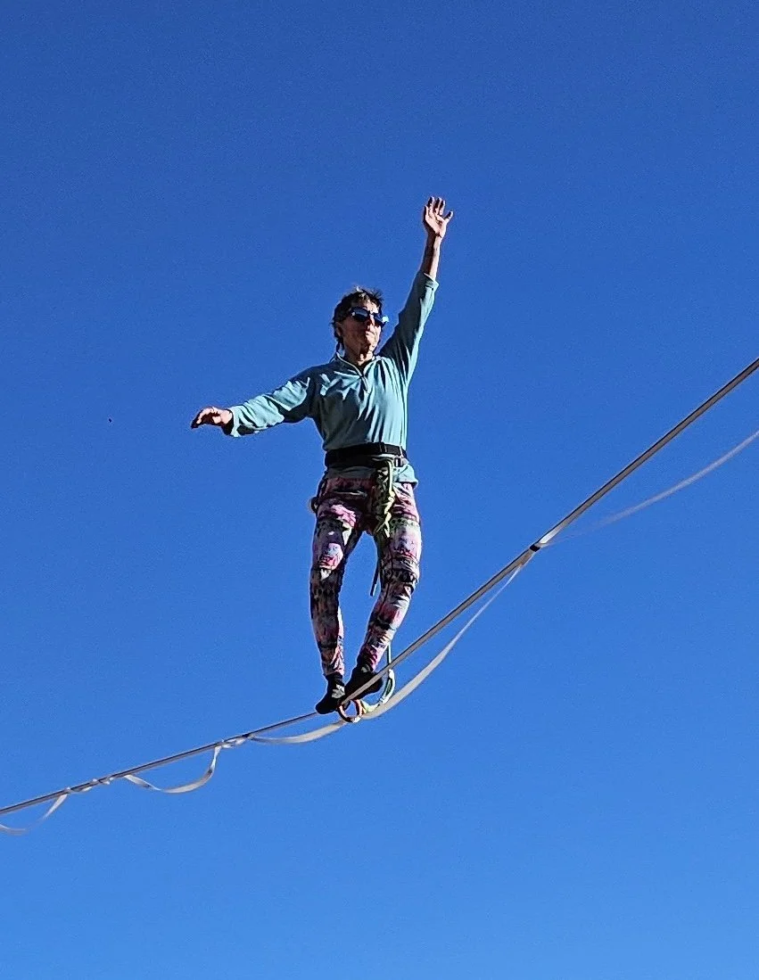Rae Raptor highlining against blue sky