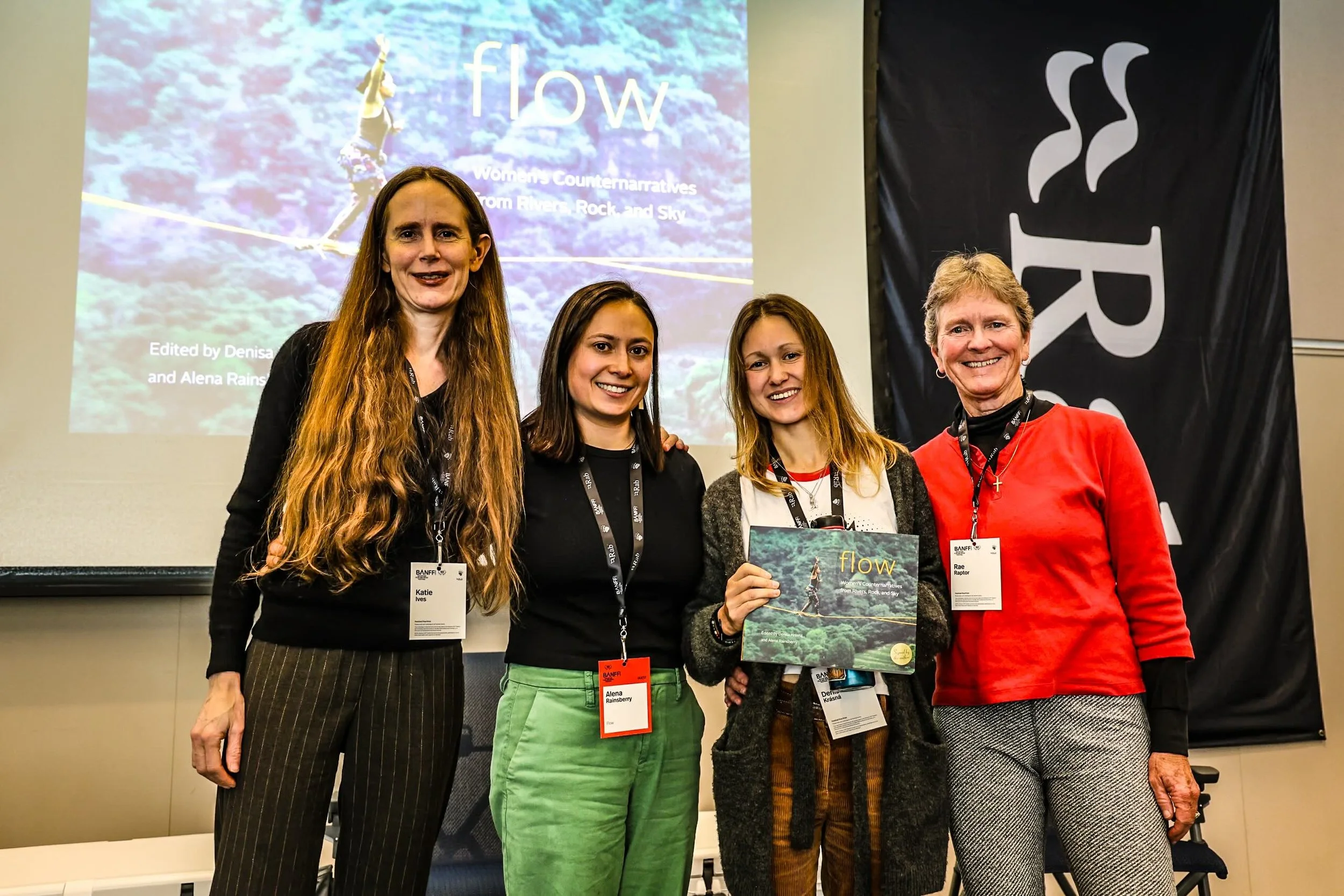 Four women panelists posing for photos at convention