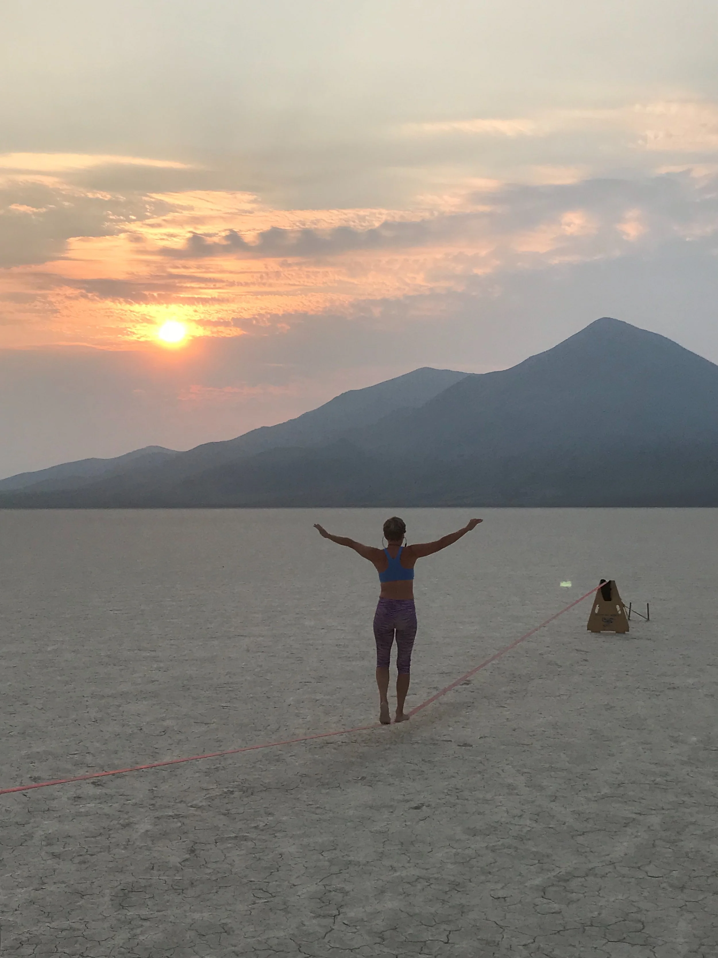 Rae Raptor sunset slacklining on Nevada playa