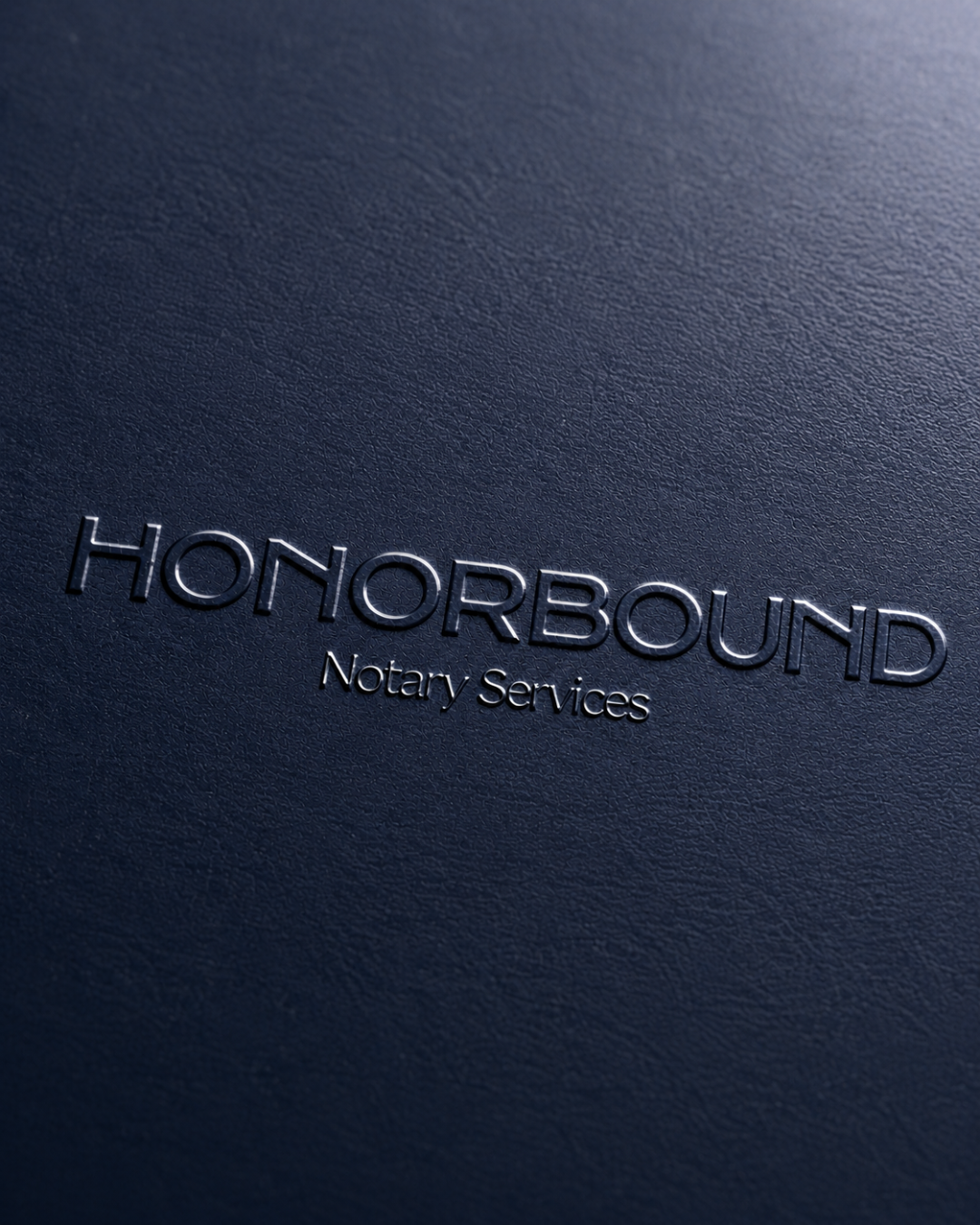 Close-up of navy blue notebook cover with embossed words "HONORBOUND Notary Services."