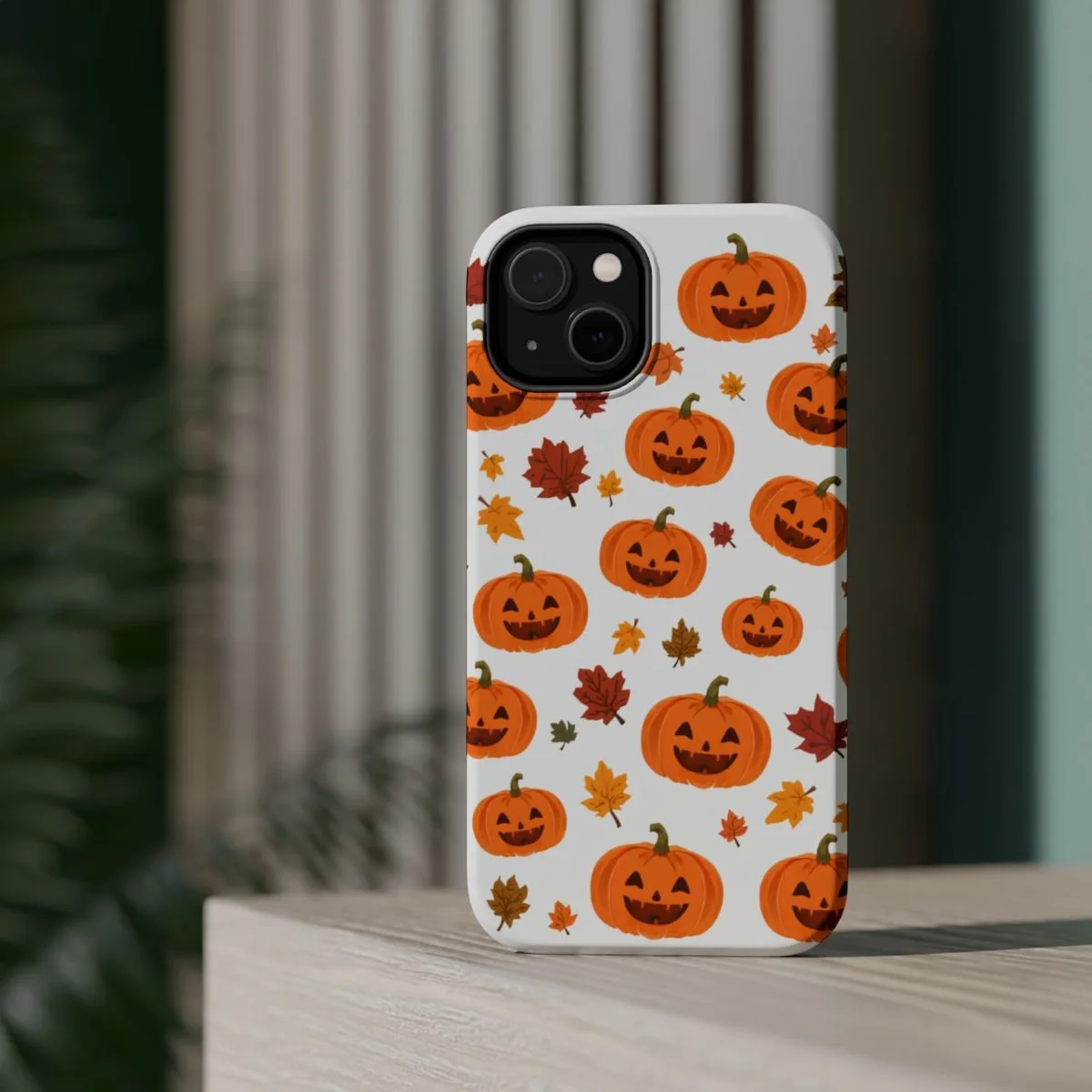 phone cover with a white background burgundy green and orange leaves and happy pumpkins though out. great for Halloween and autumn