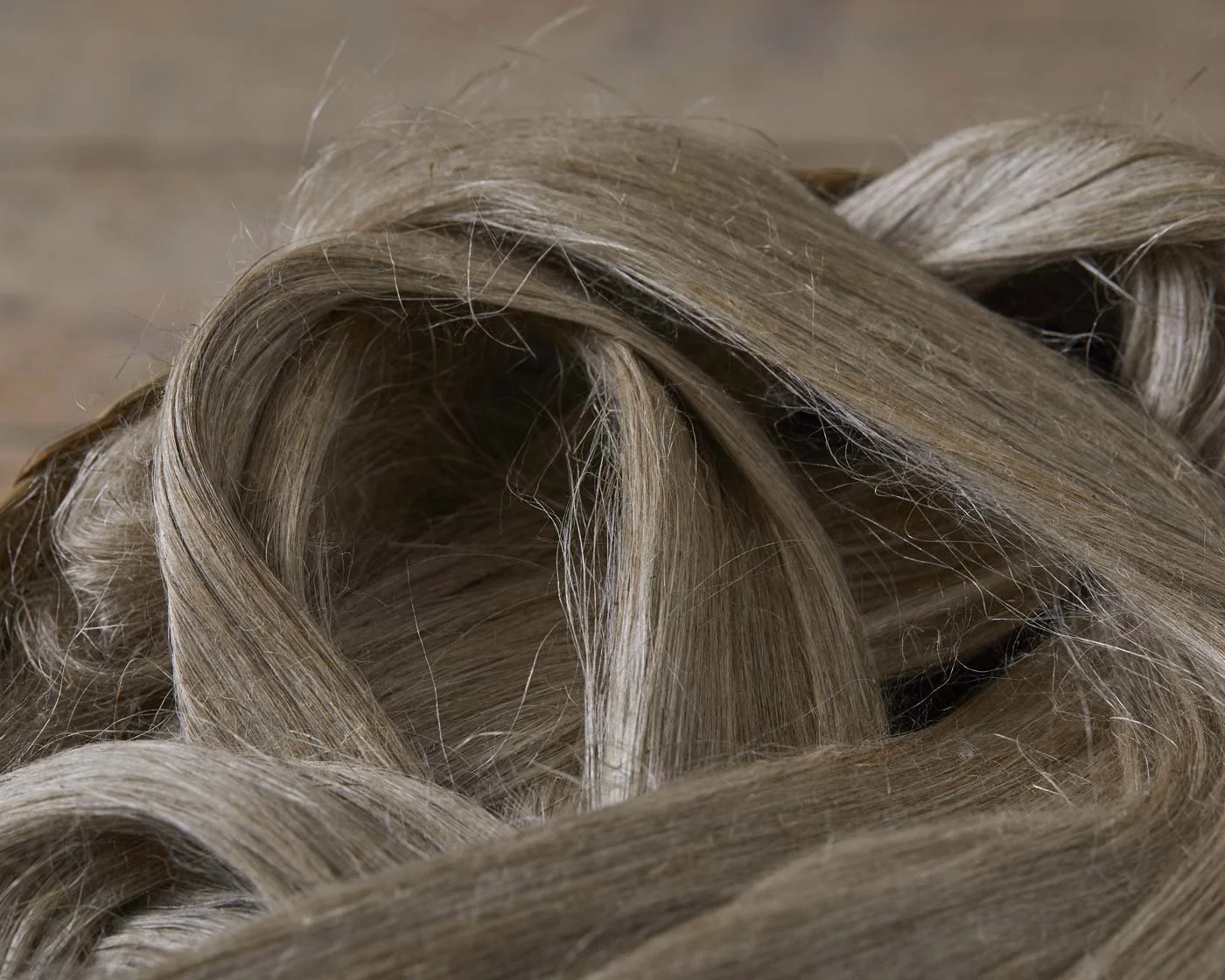 Close-up of blonde human hair styled in loose curls.