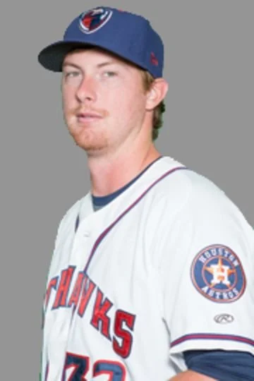 Portrait of a young man in a Houston Astros baseball jersey and cap.