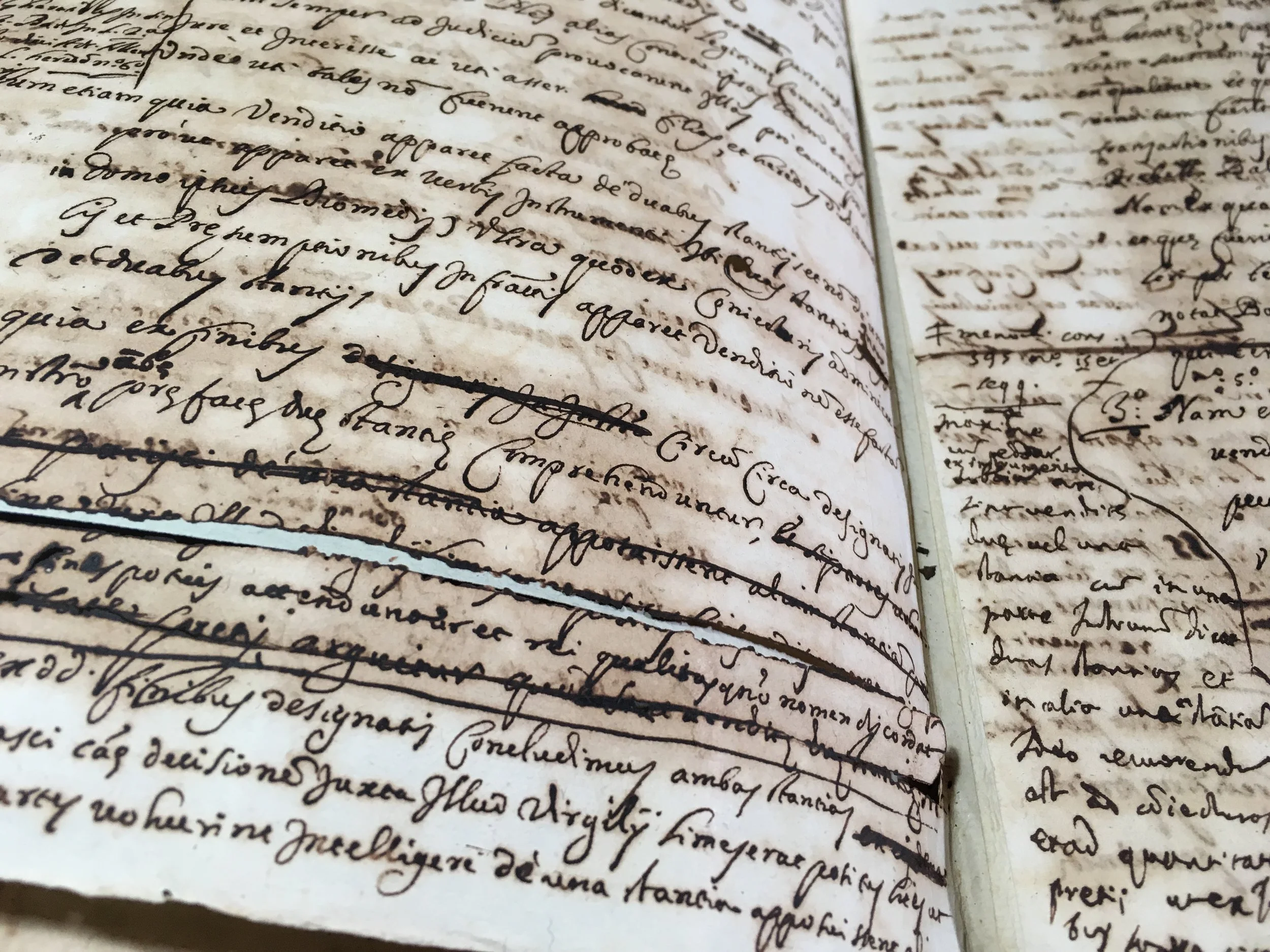 Ancient handwritten manuscript with cursive script on aged paper.