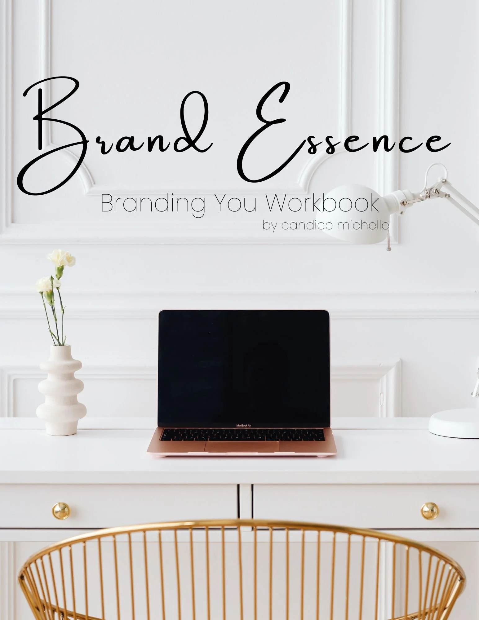 White desk with a vase holding white flowers, a closed rose gold laptop, and a white lamp, against a white wall with decorative molding. Text overlay reading 'Brand Essence' and 'Branding You Workbook by Candice Michelle'.
