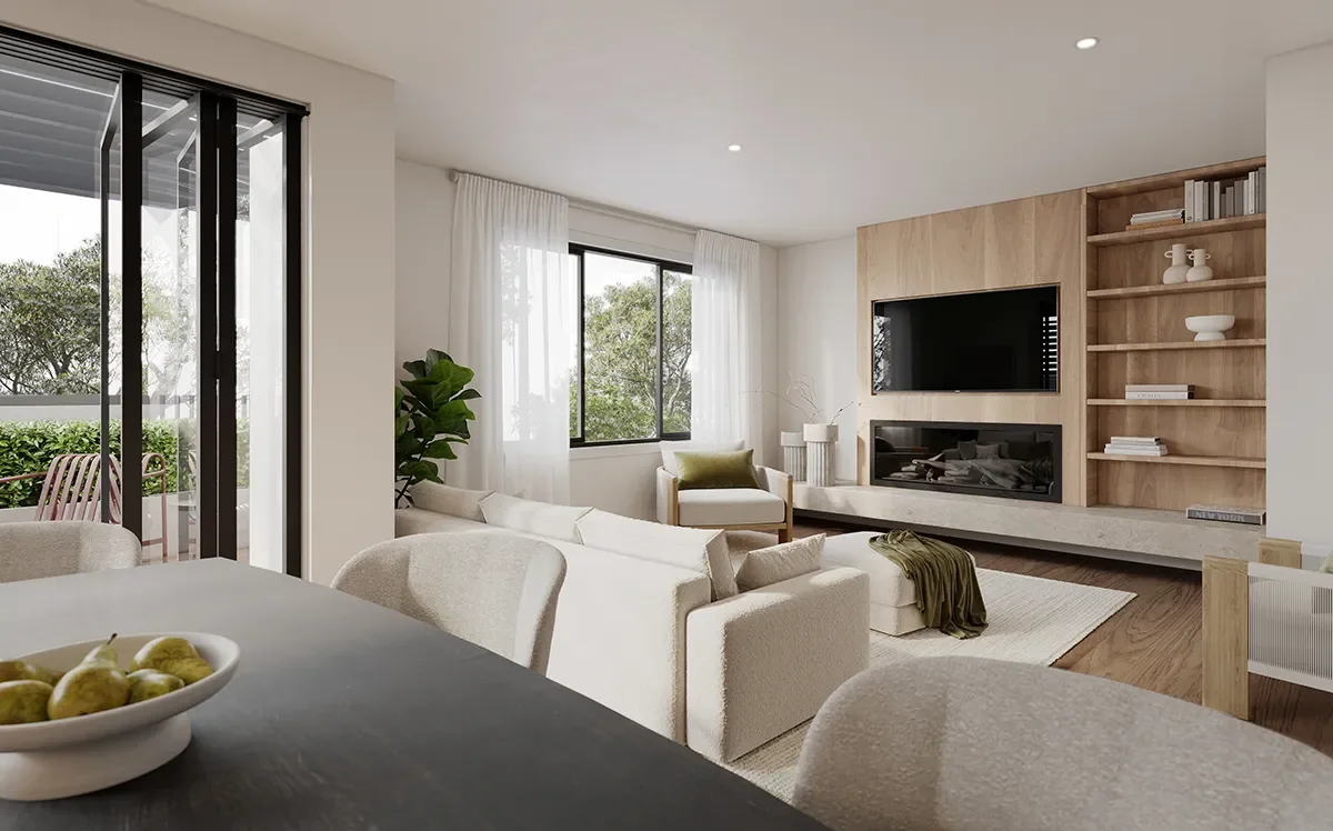 Modern living room with large window, built-in wooden shelves, flat-screen TV, beige sofas, dining table with bowl of pears, and patio with outdoor furniture visible through sliding glass door.