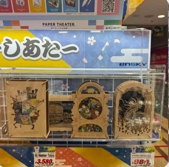 Display of Japanese-themed puzzle boxes and wooden souvenirs in a store exhibit.