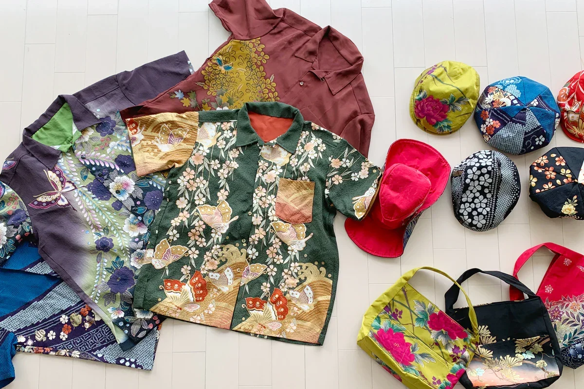 Items such as button down tshirts, hats and handbags each made out of kimono fabric.
