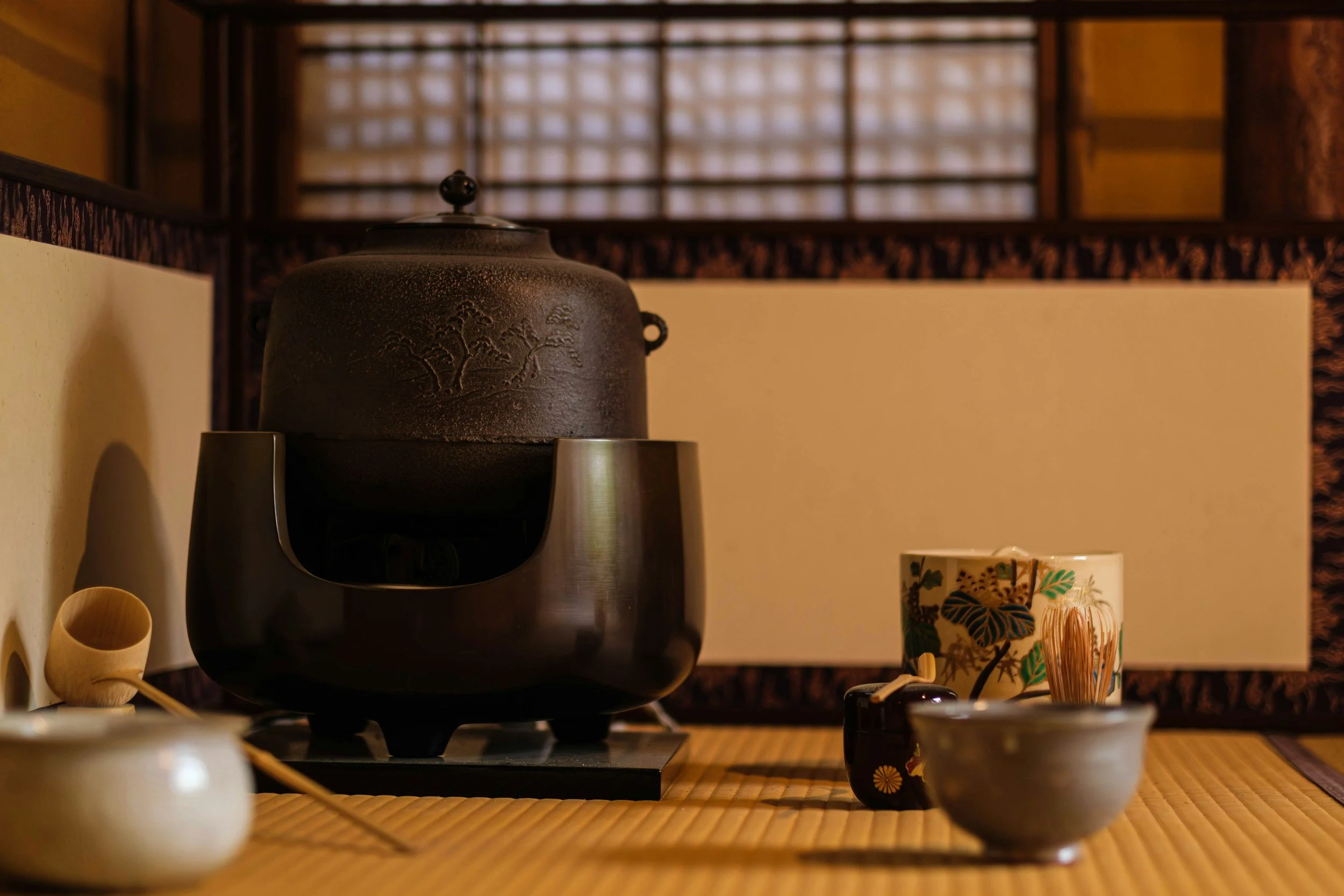Tea ceremony equipment including pot, tea cup, whisk, ladle and matcha jar.