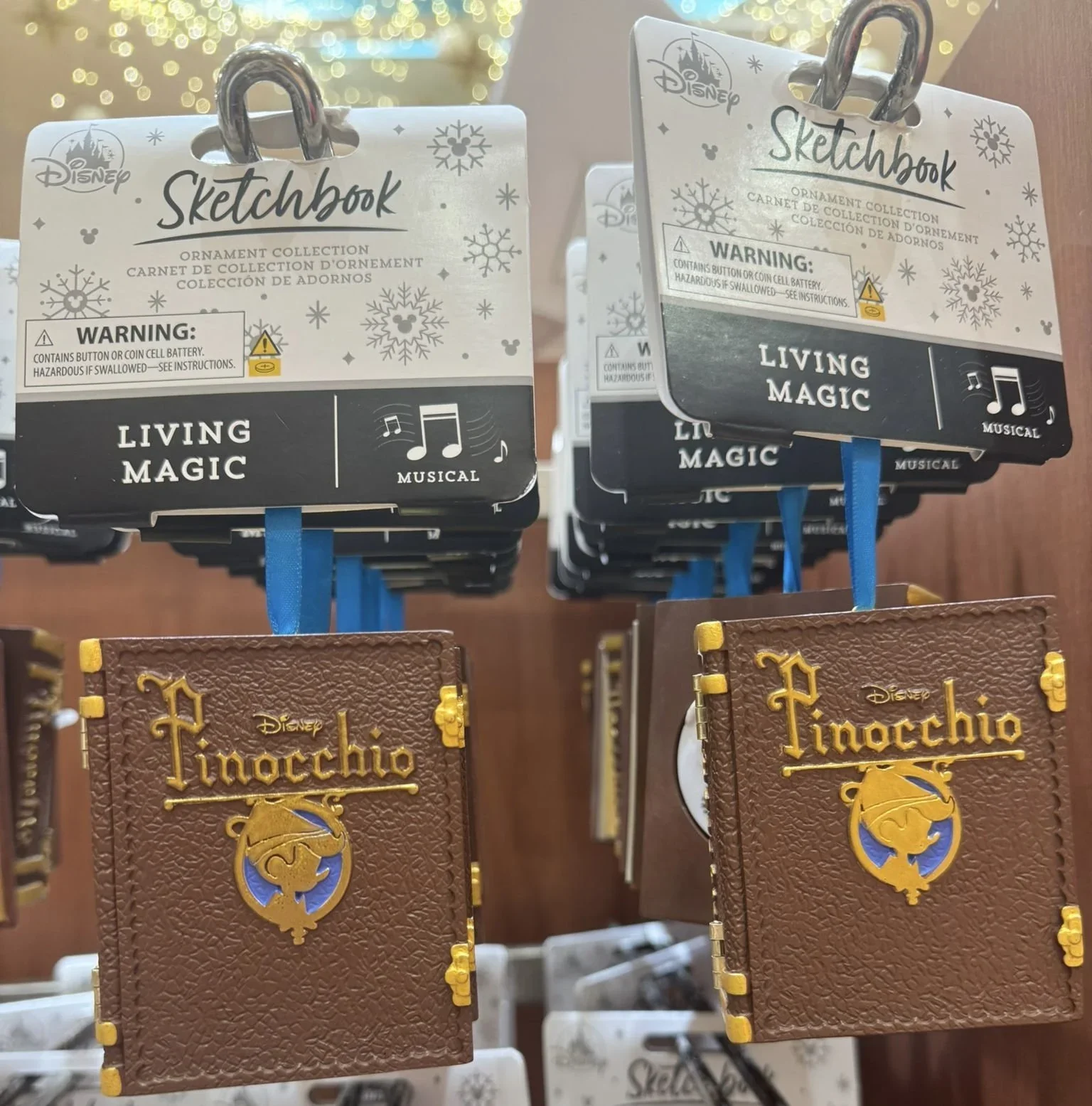 Pinocchio Book themed ornaments hand from a rack.