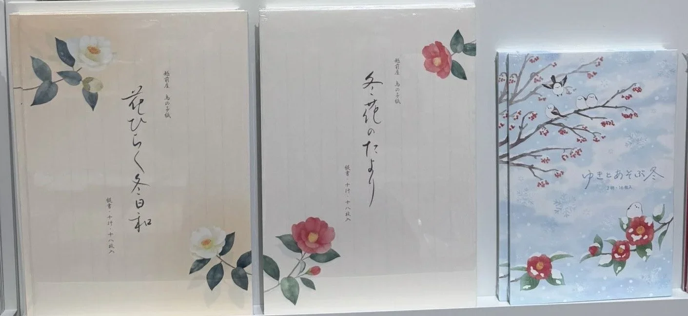Japanese stationary sets for writing calligraphy featuring winter camellia flowers.