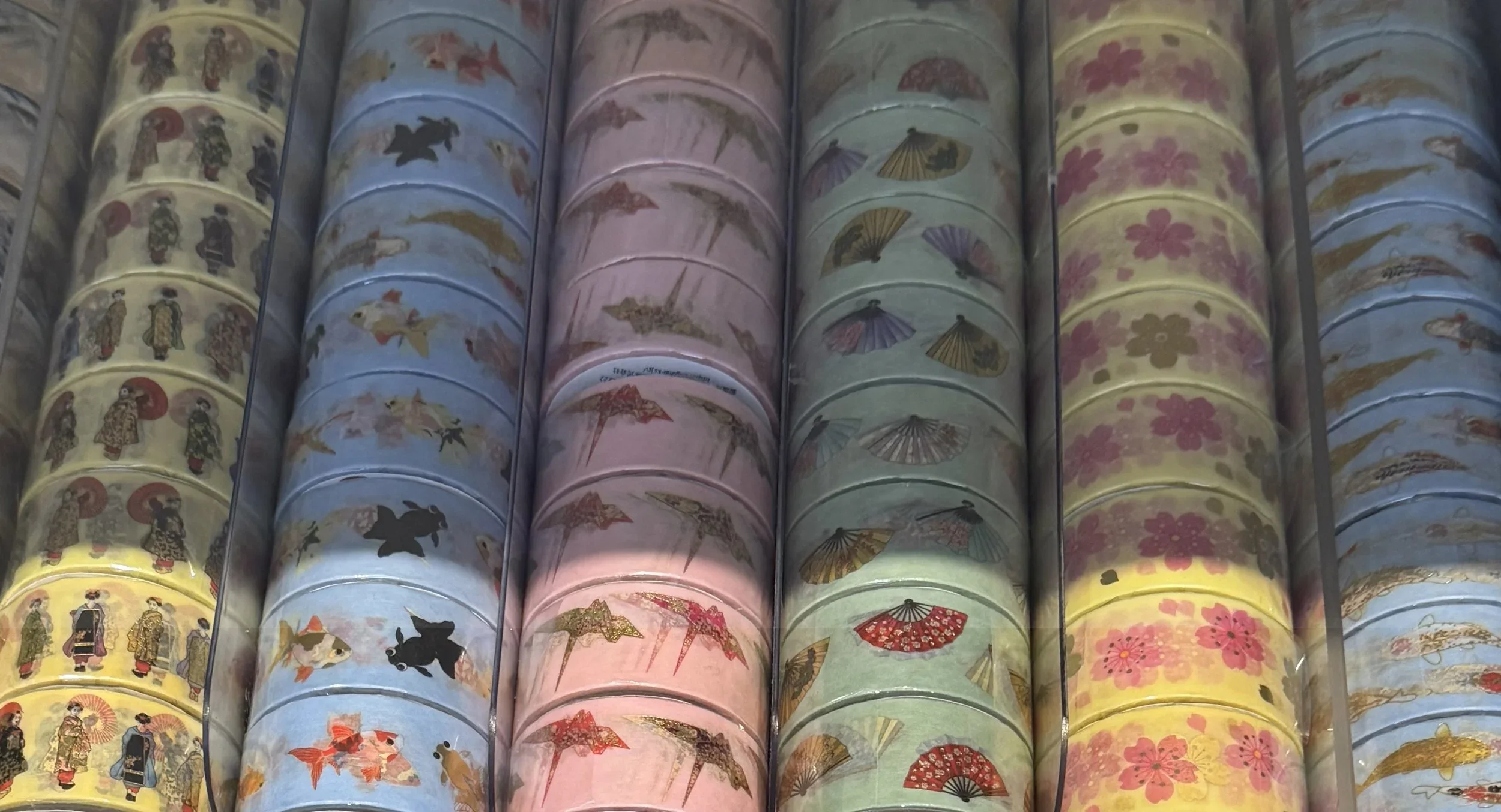 Washi tape with Japanese designs lined up in rows.