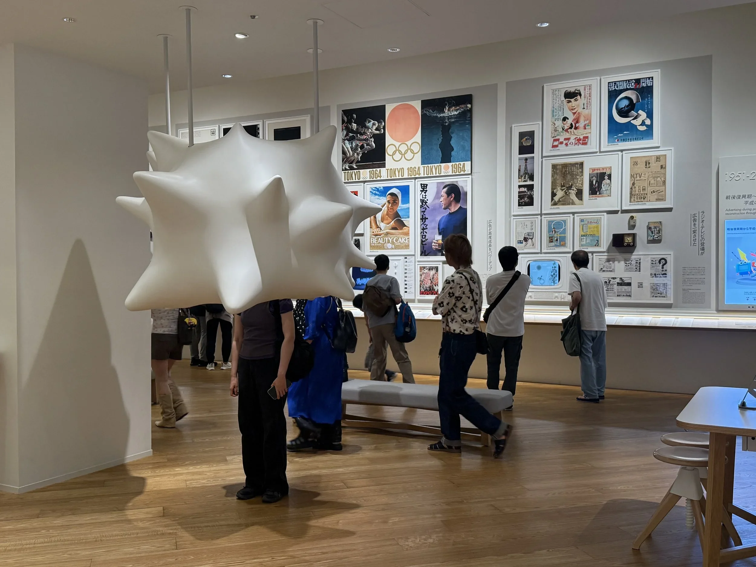 Interactive display that looks like a floating popcorn kernel in the foreground and posters mounted to the wall in the background.