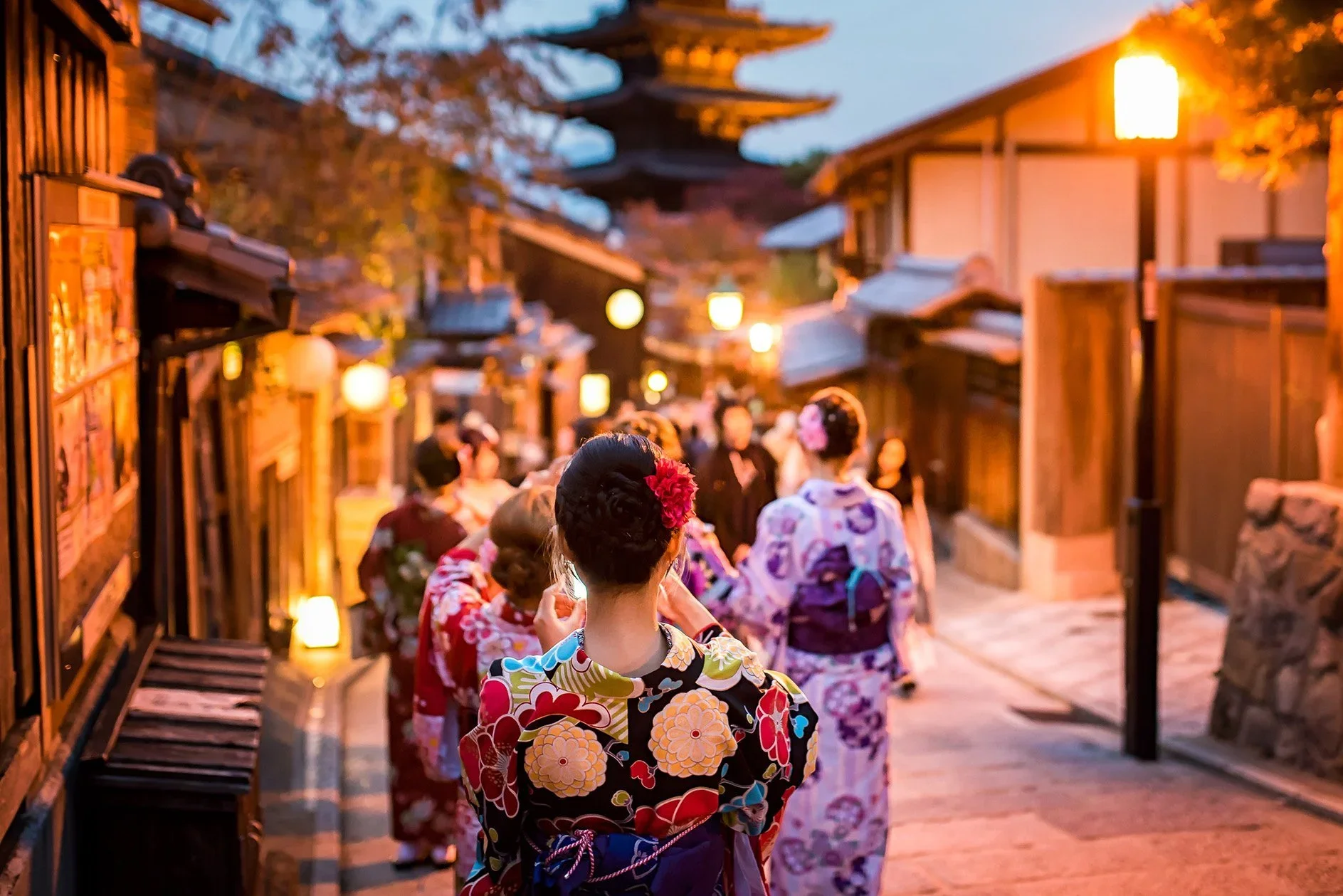 Visitors to Kyoto Japan wear a cotton summer Kimono while exploring the traditional Japanese streets.