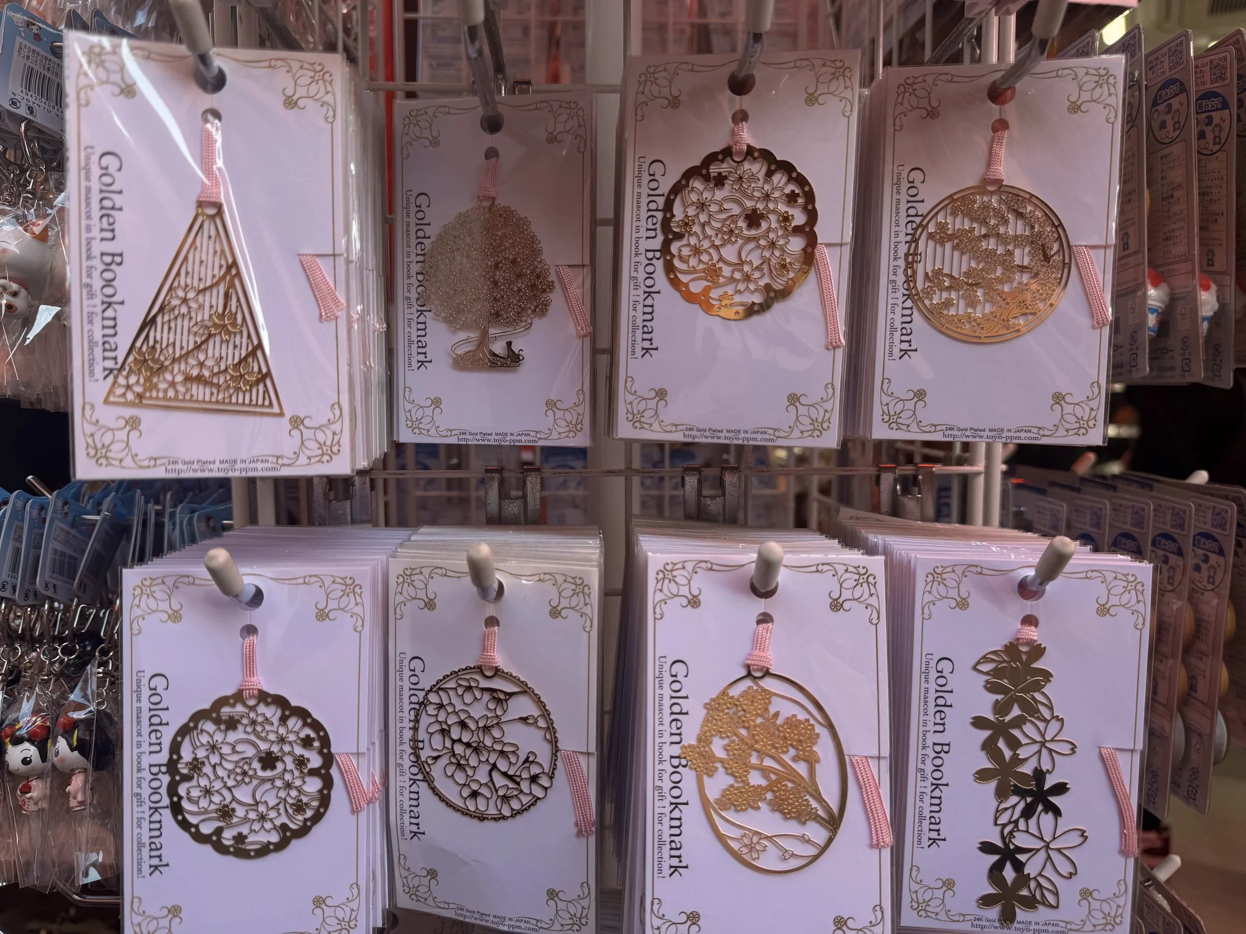 Thin metal gold plated bookmarks with cherry blossom designs.