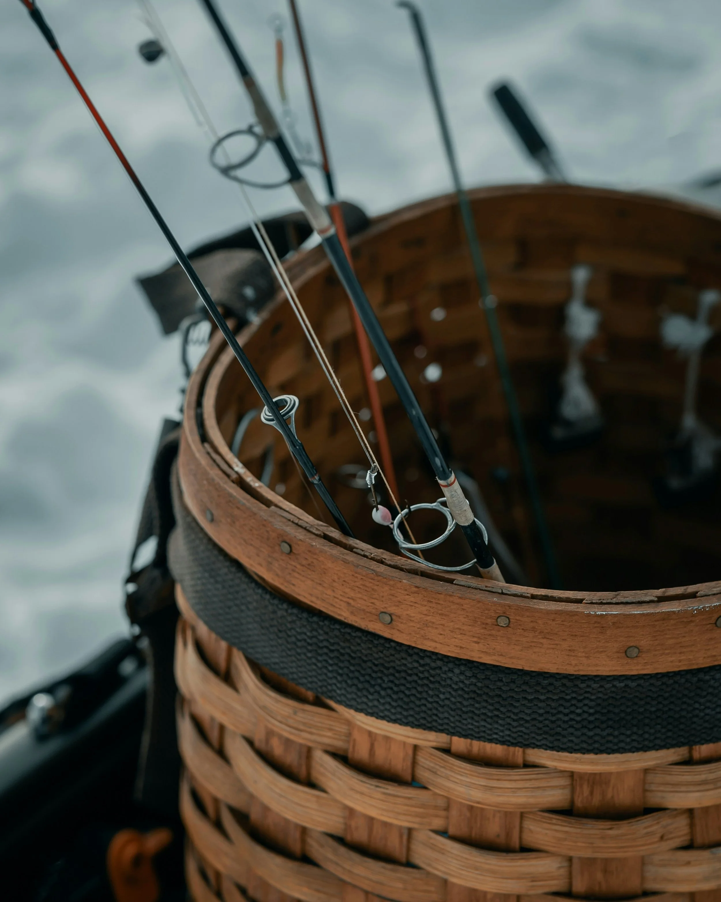 a close up of fishing rods in a woven basket