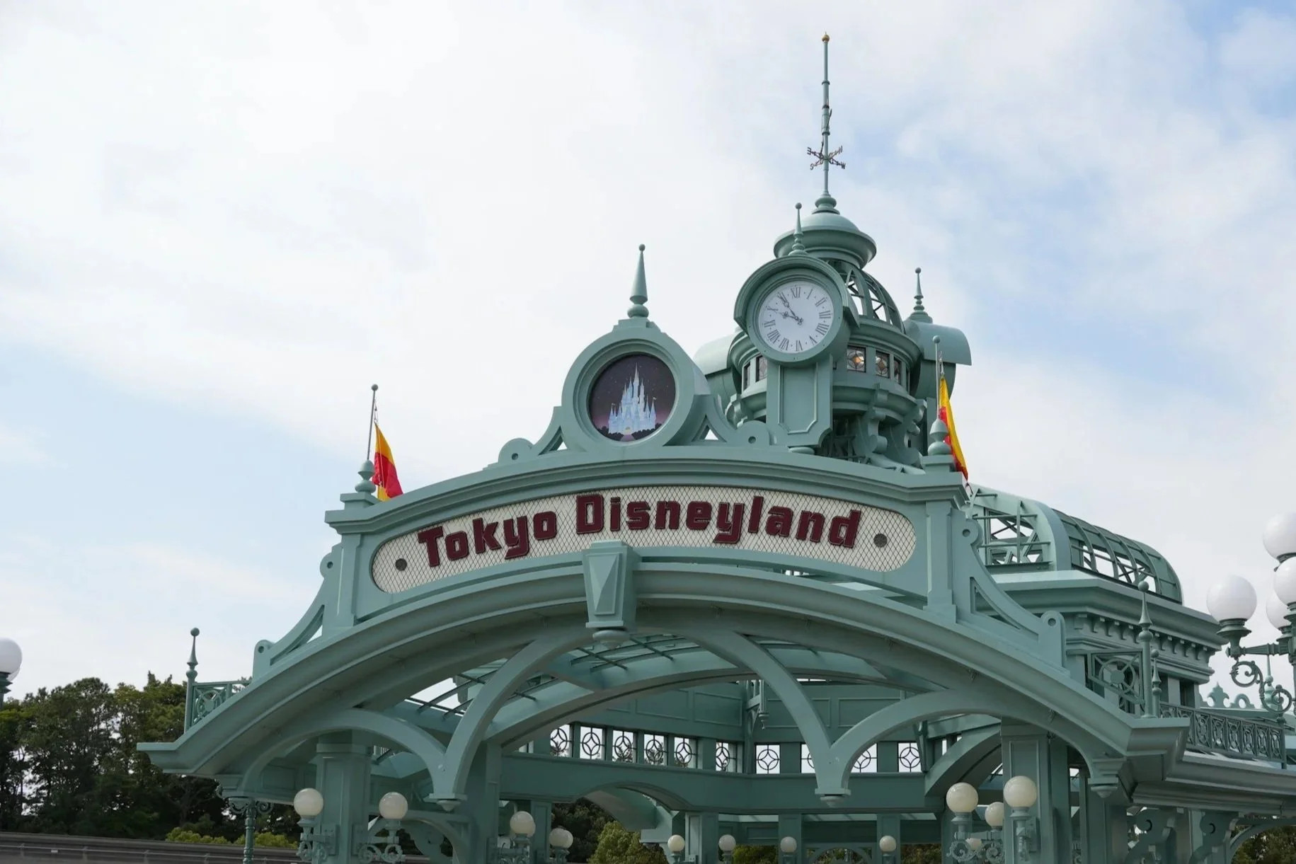 Geen Entrance way gazebo to Tokyo Disney on a cloudy sunny day.