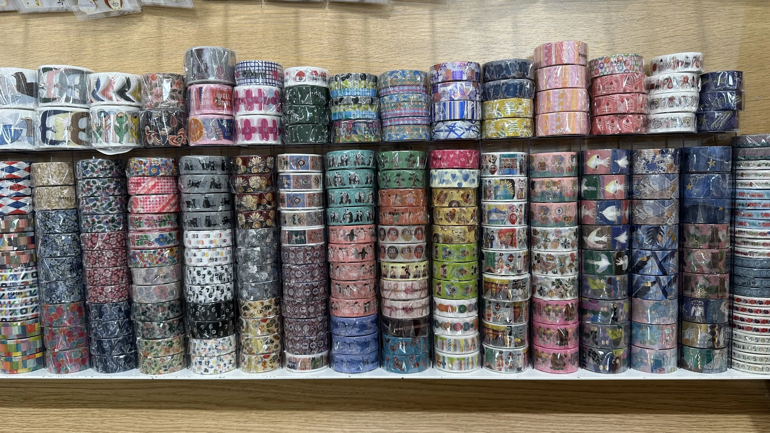 8 columns of colorful patterns of Japanese washi tape stacked 12 or 13 rolls tall.
