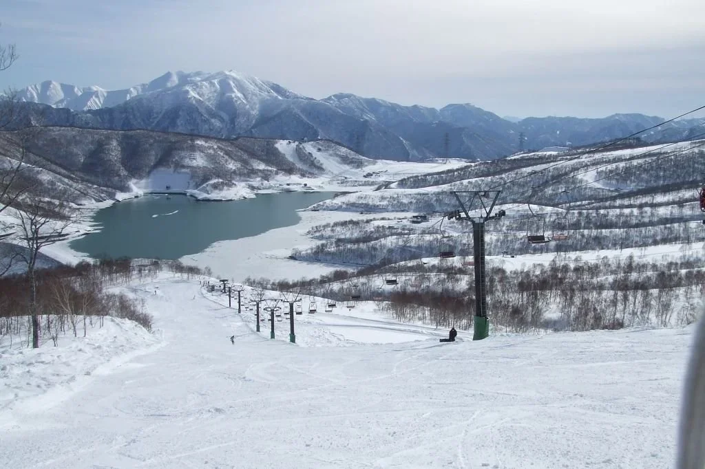 Lake nestled among the mountains in winter at the Kagura Ski Resort in Japan.
