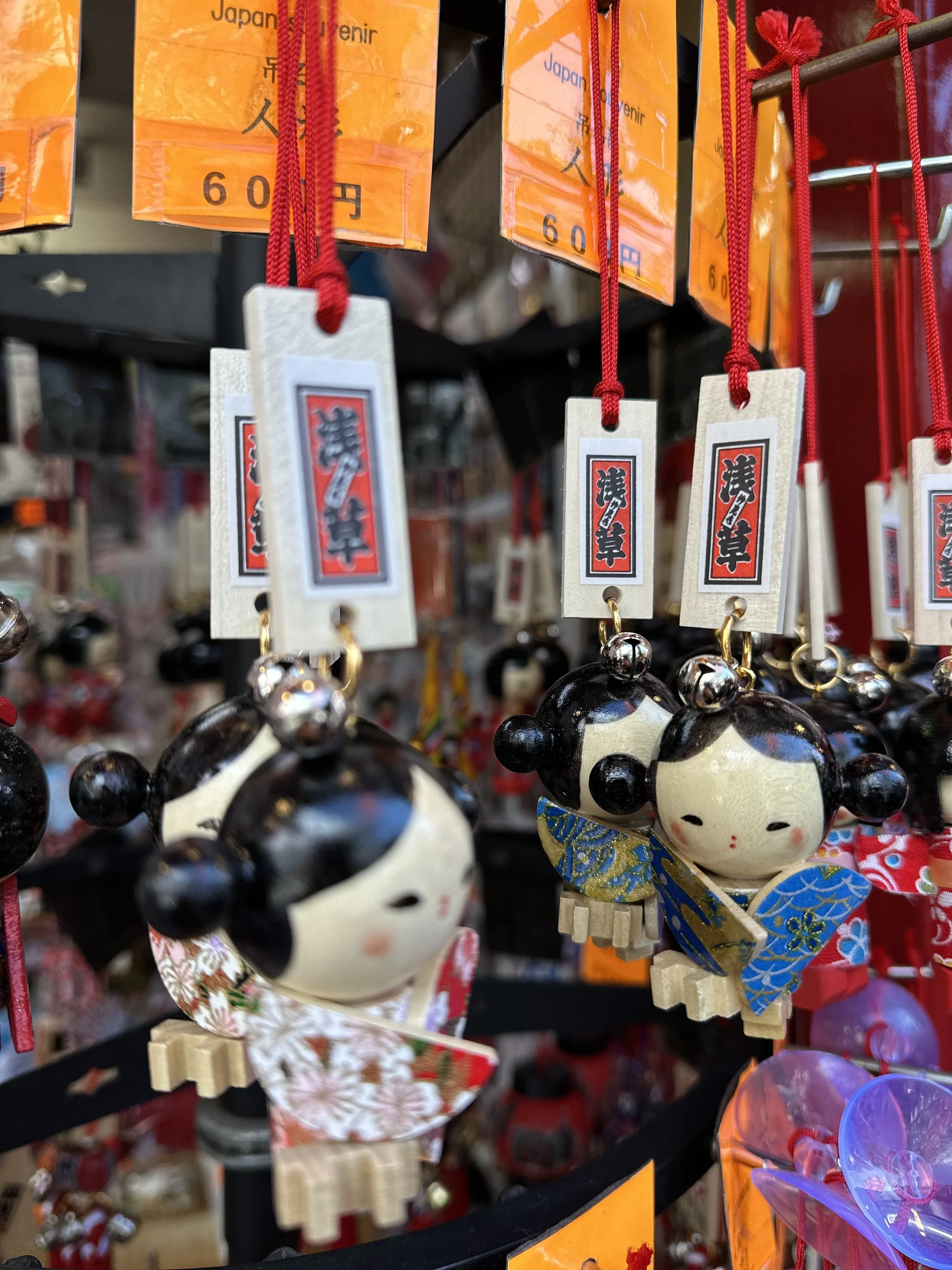 Handmade wooden charms on a string of a girl in a multicolored paper kimono