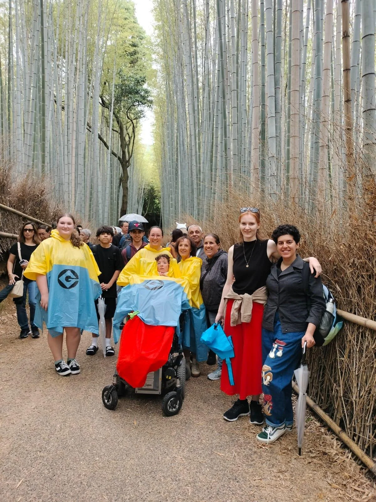 A family poses in arashiyama, kyoyo for a photo.