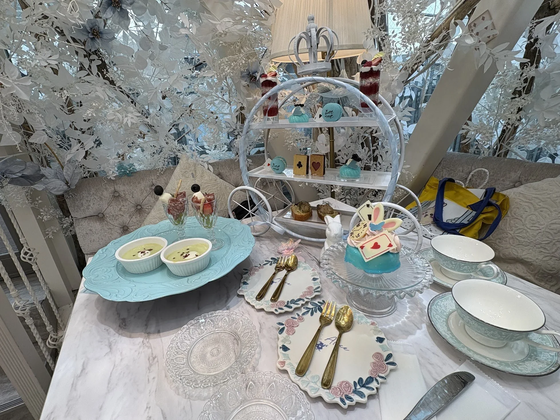 A fairy-tale-like high-tea table setting of blues and pastels.