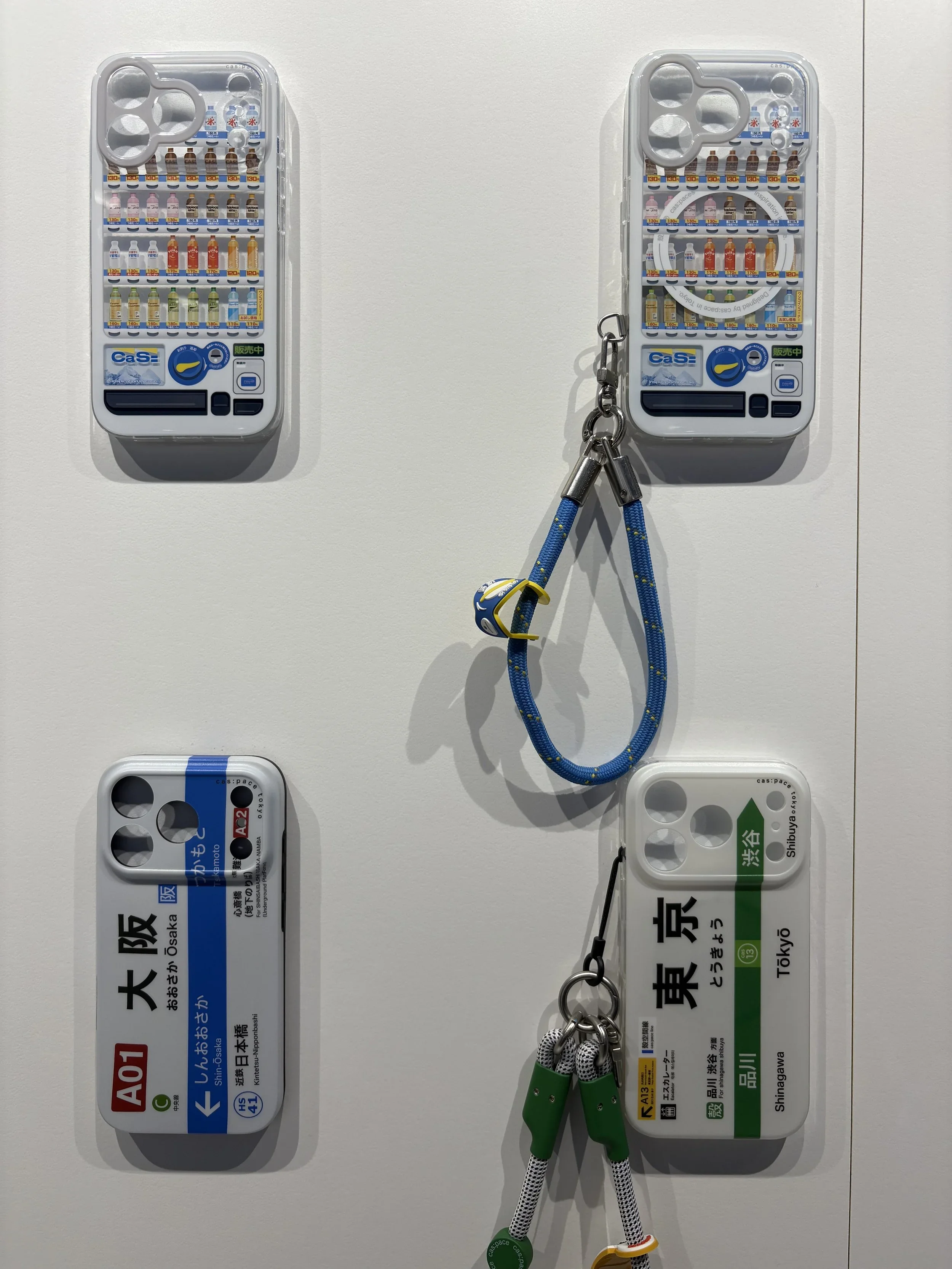 Japanese inspired cell phone cases with the JR station subway signs or a vending machine printed on them.
