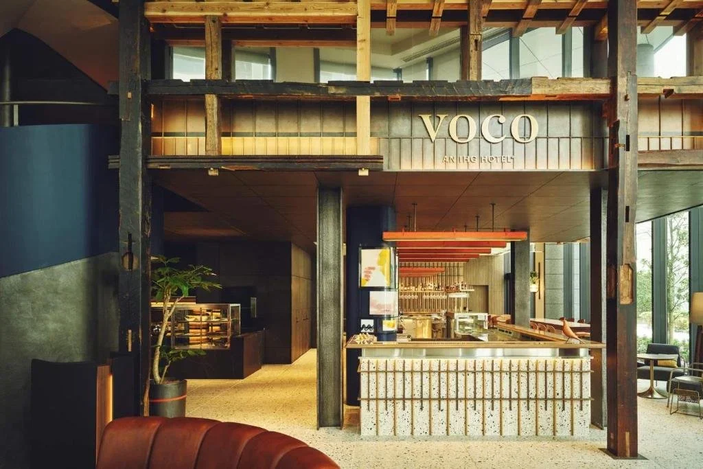 Voco Osaka Central lobby of warm woods and an artistic vibe.
