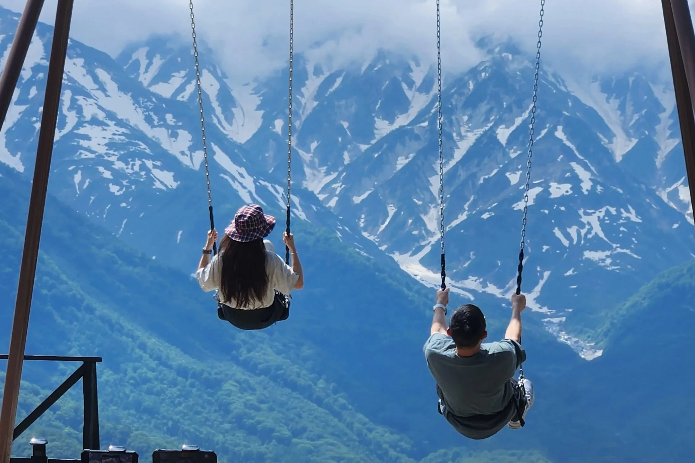 A couple swings in the Japanese mountainside.