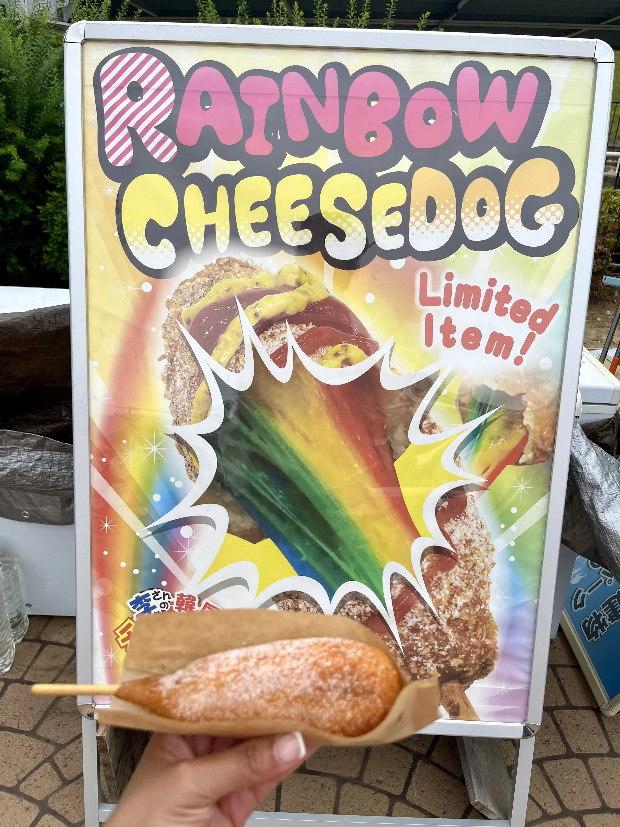 A sign advertising a limited item rainbow cheese dog.